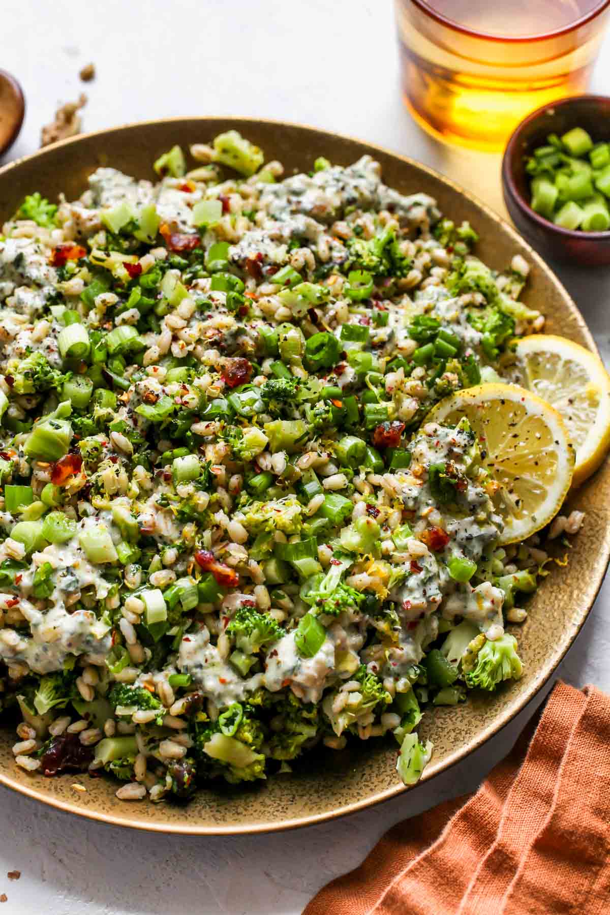Farro salad on a plate topped with creamy walnut dressing