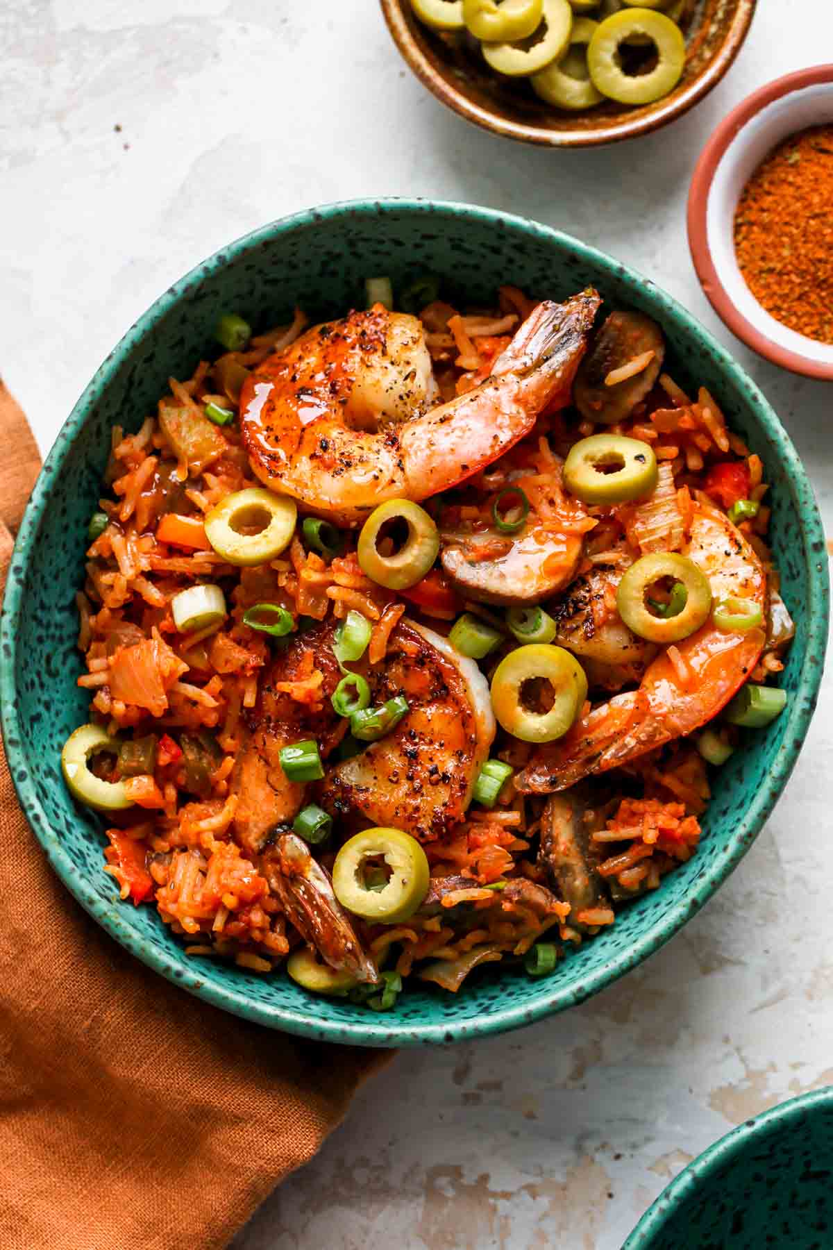 Teal bowl filled with portion of shrimp Jambalaya