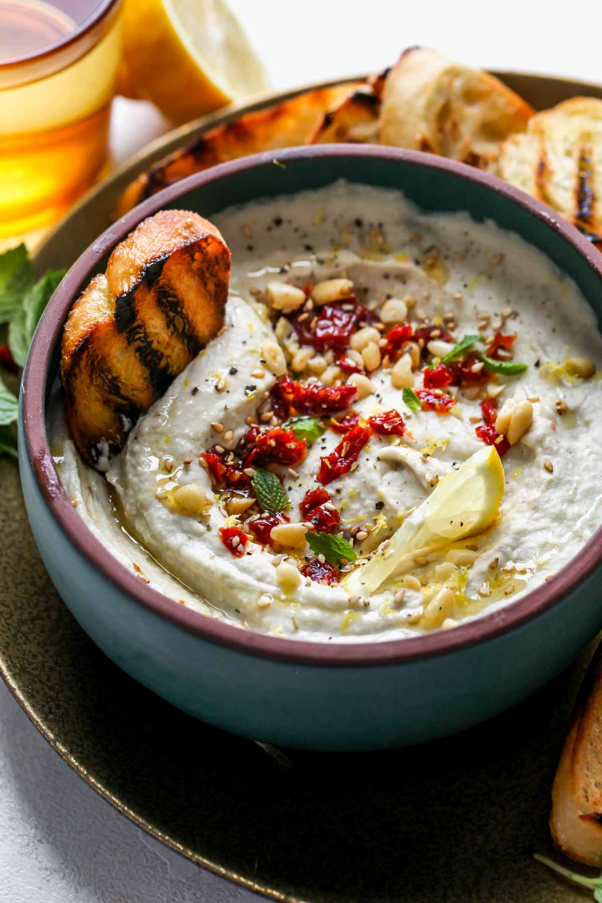 Sun-dried tomato dip with grilled bread on a platter