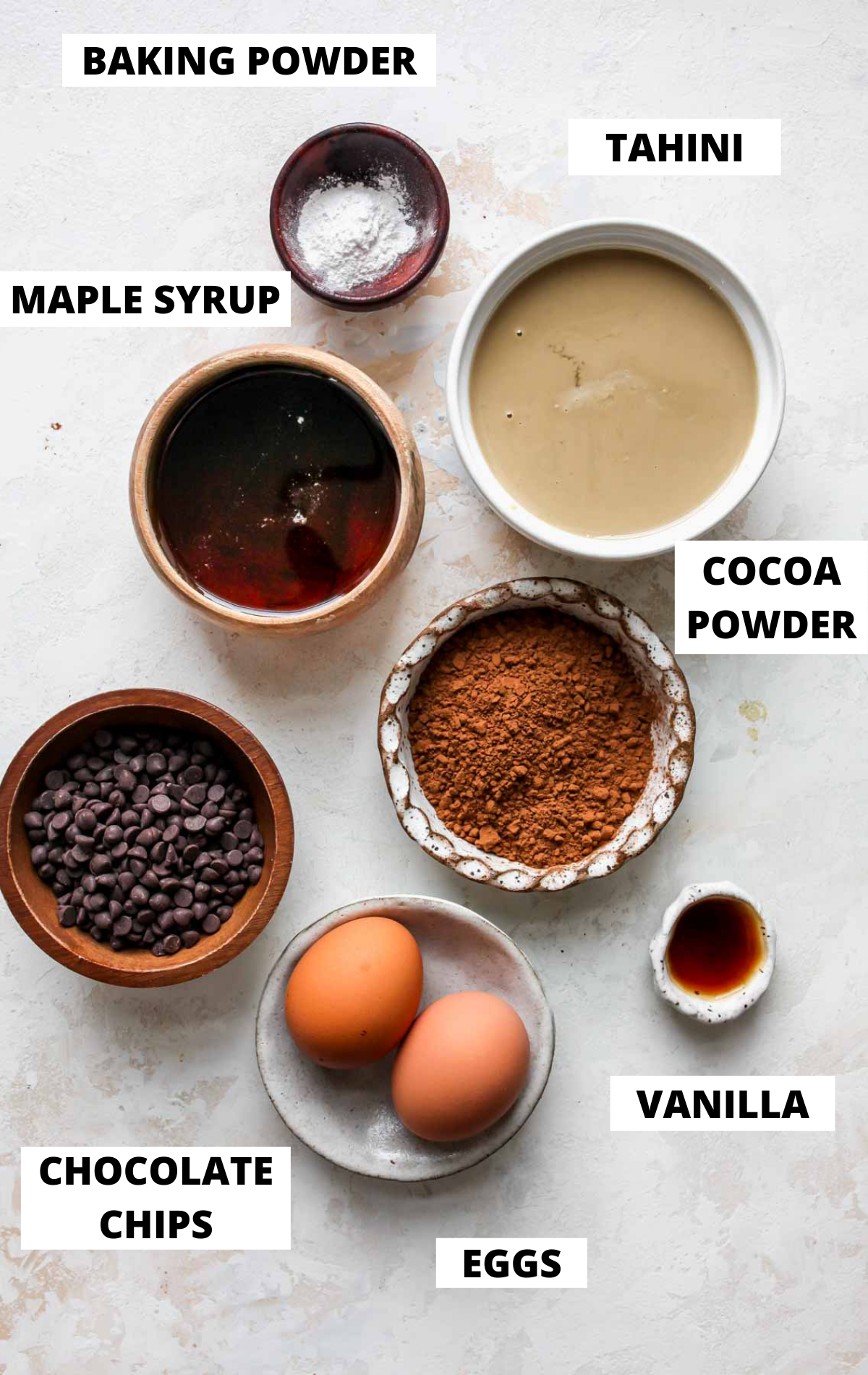 Recipe ingredients in bowls on a white board with labels
