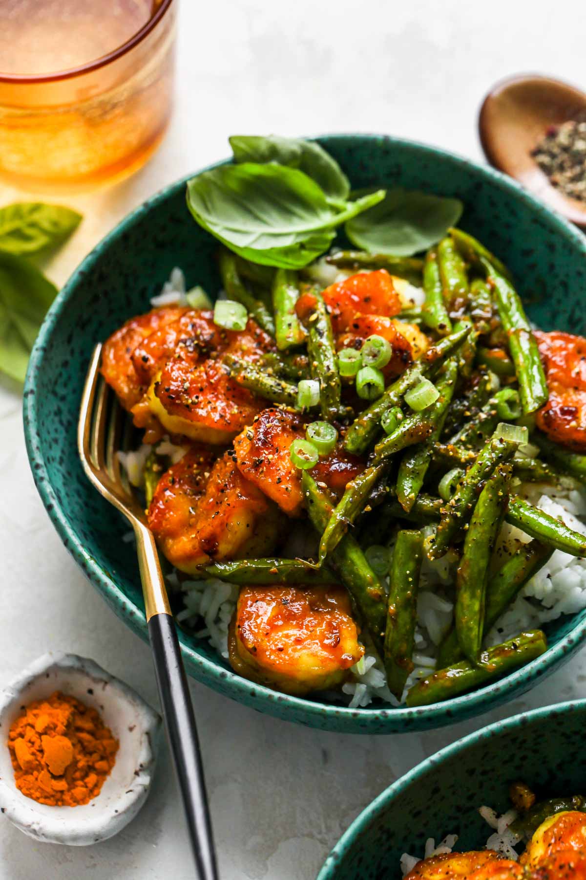 Black pepper prawns and haricots verts in a teal bowl