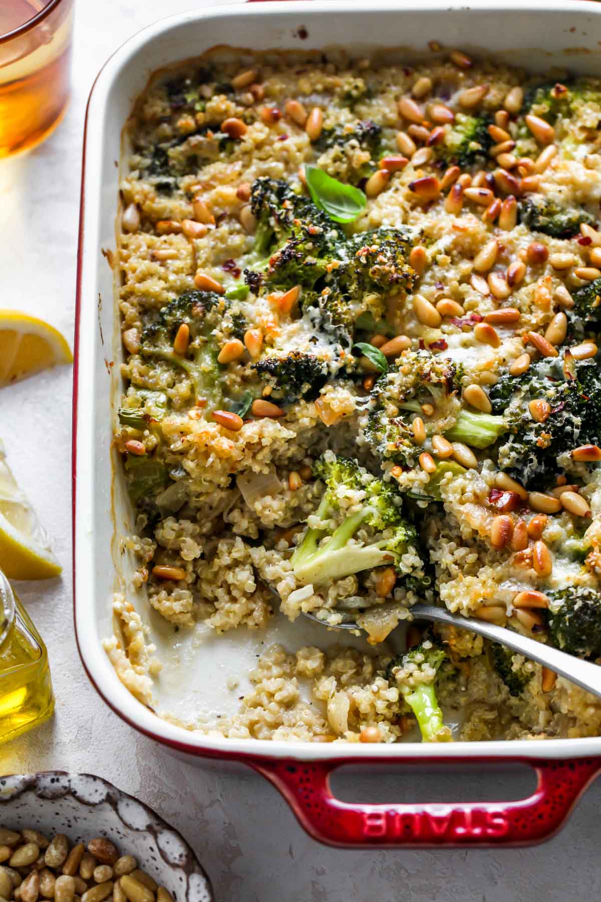 Broccoli quinoa casserole after being baked with a spoon digging out a portion