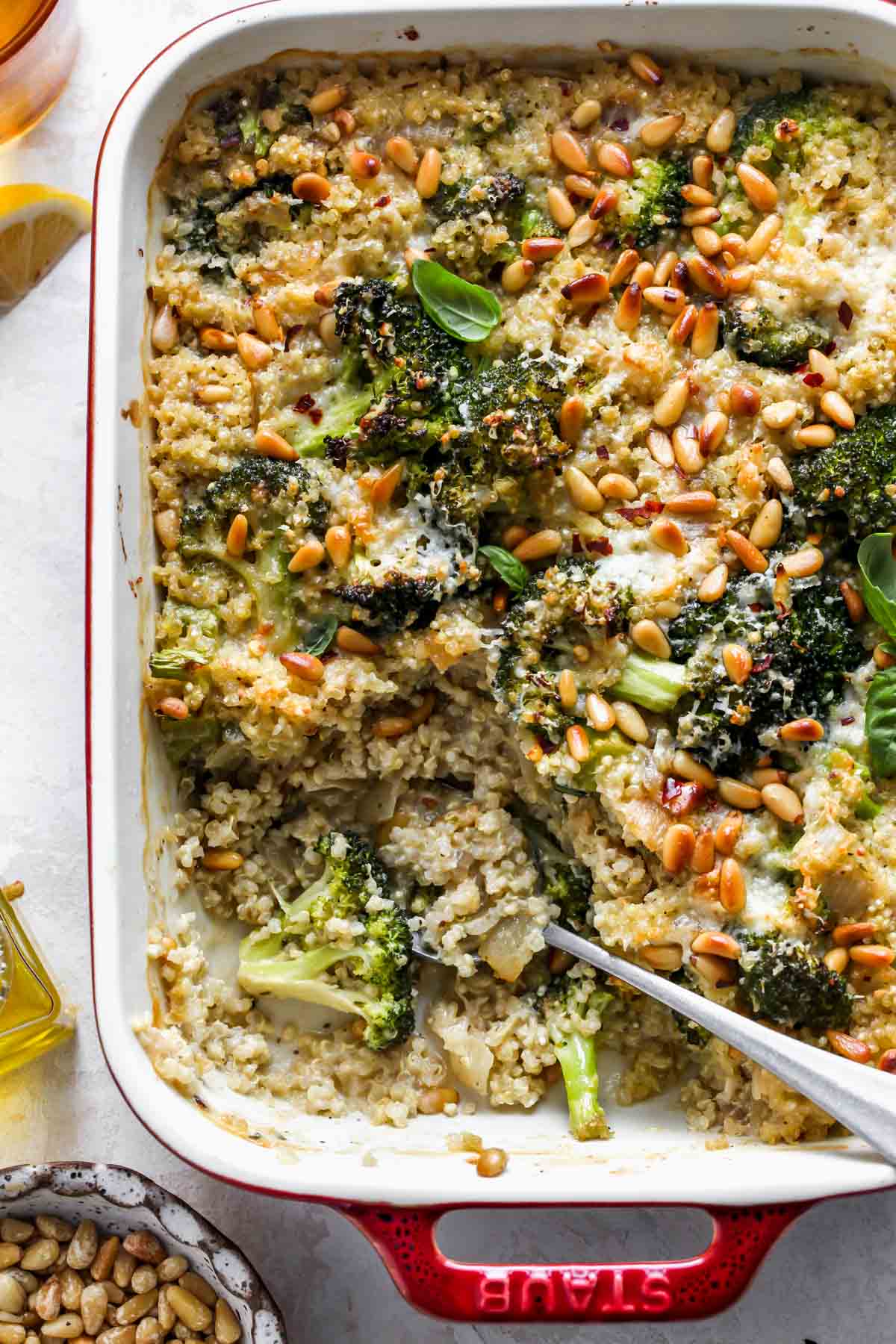 Broccoli quinoa casserole in a red baking dish