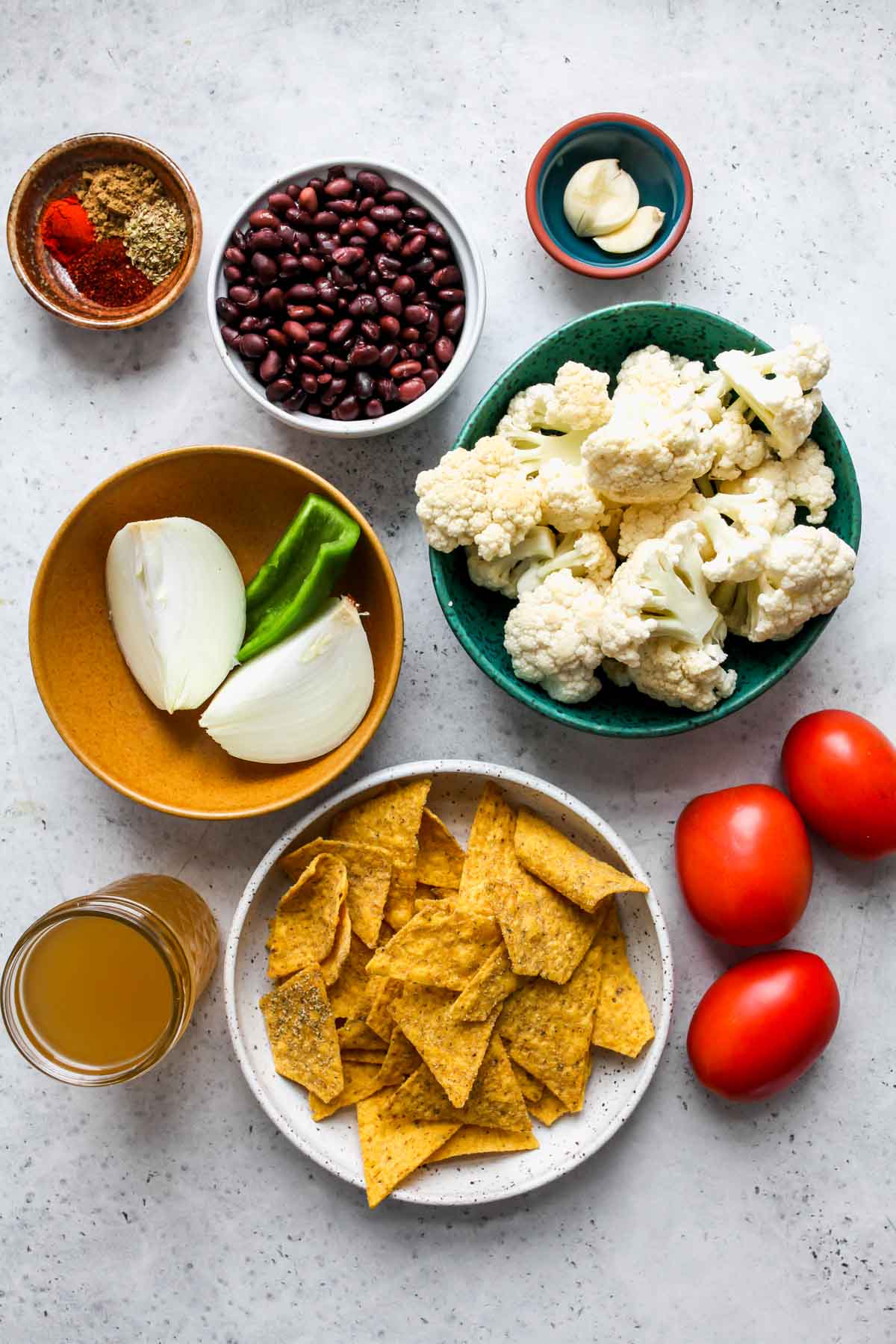 Cauliflower Chilaquiles ingredients in separate bowls on a white board