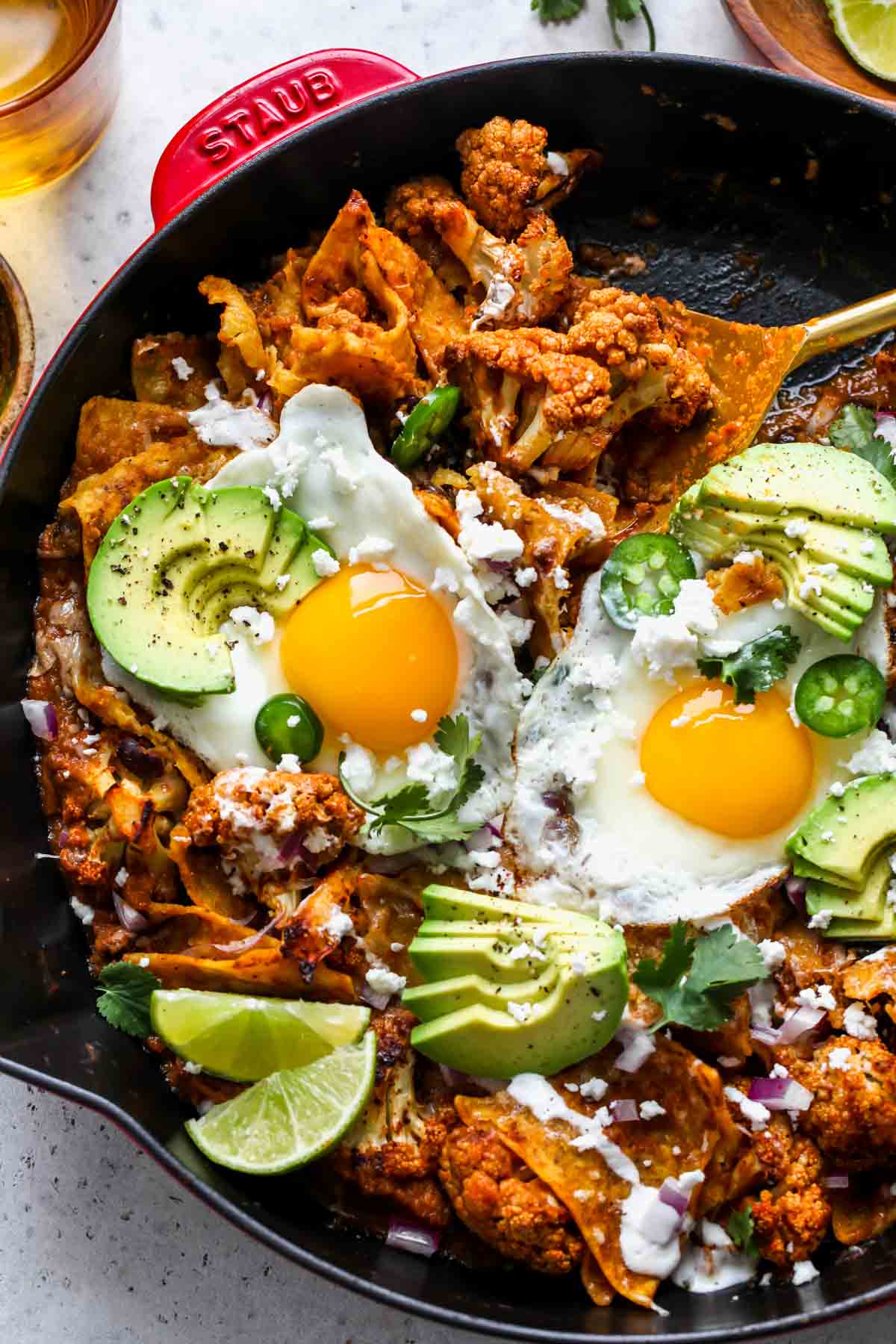 A serving spoon scooping out a portion of chilaquiles
