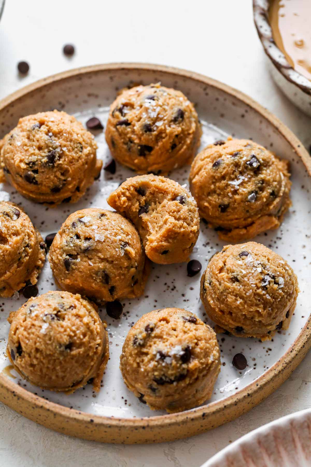 Cookie dough protein balls on a small white plate