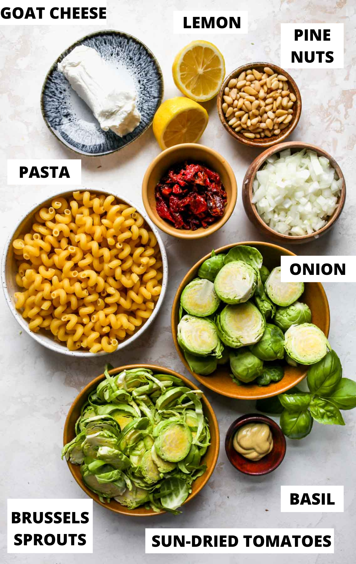 Recipe ingredients in separate bowls with white labels