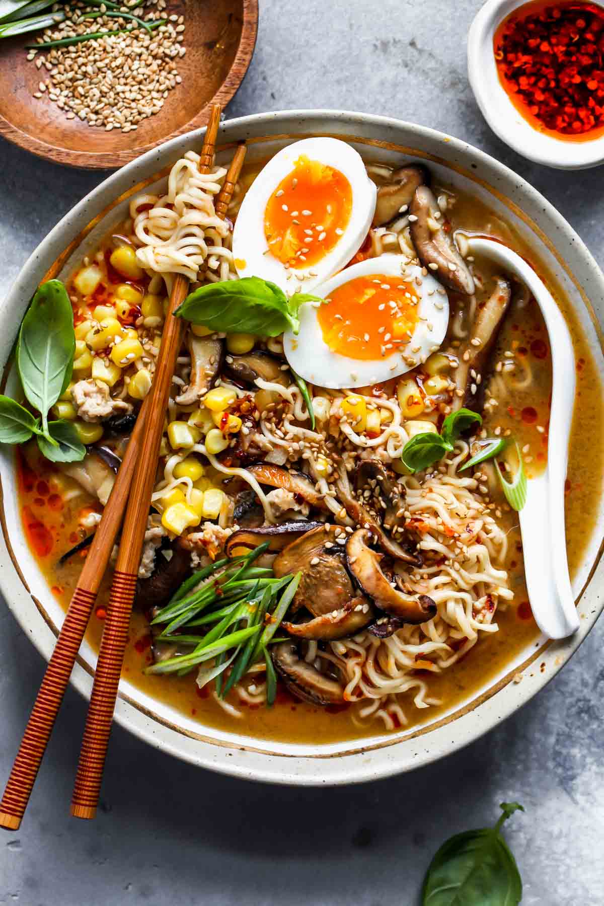 Miso ramen soup in a bowl topped with a soft-boiled egg and scallions.