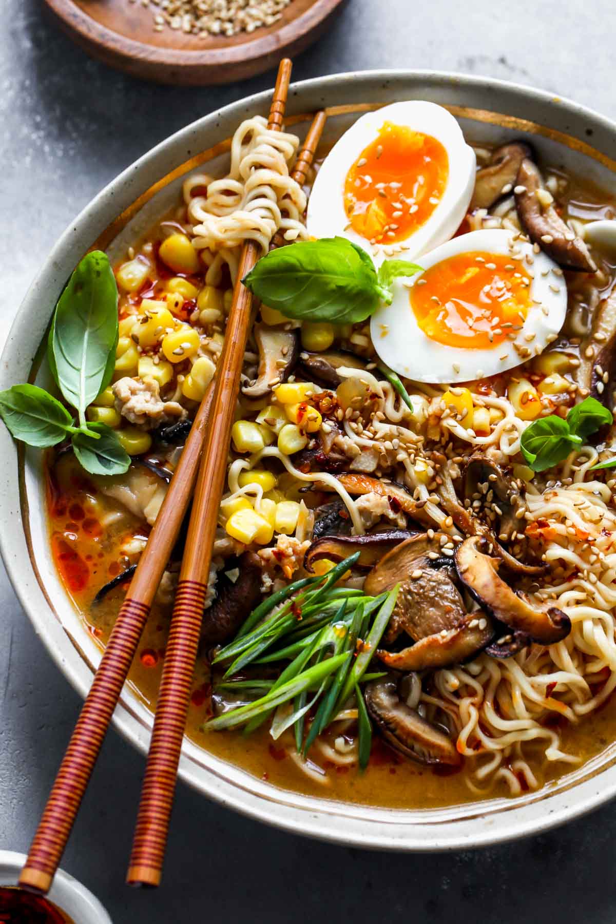 Homemade ramen recipe in a bowl with chopsticks twirling noodles.