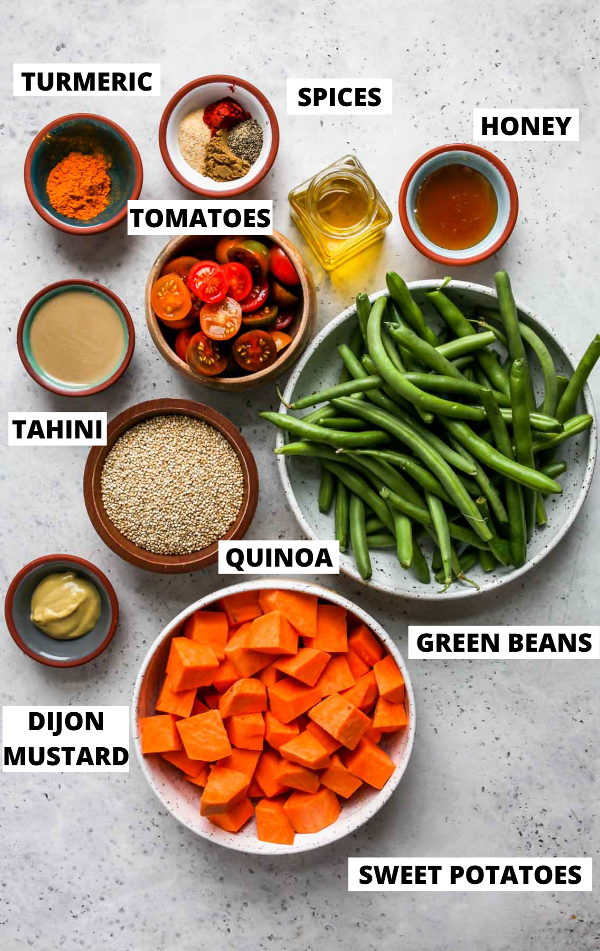 Recipe ingredients in separate bowls on a white board with labels.