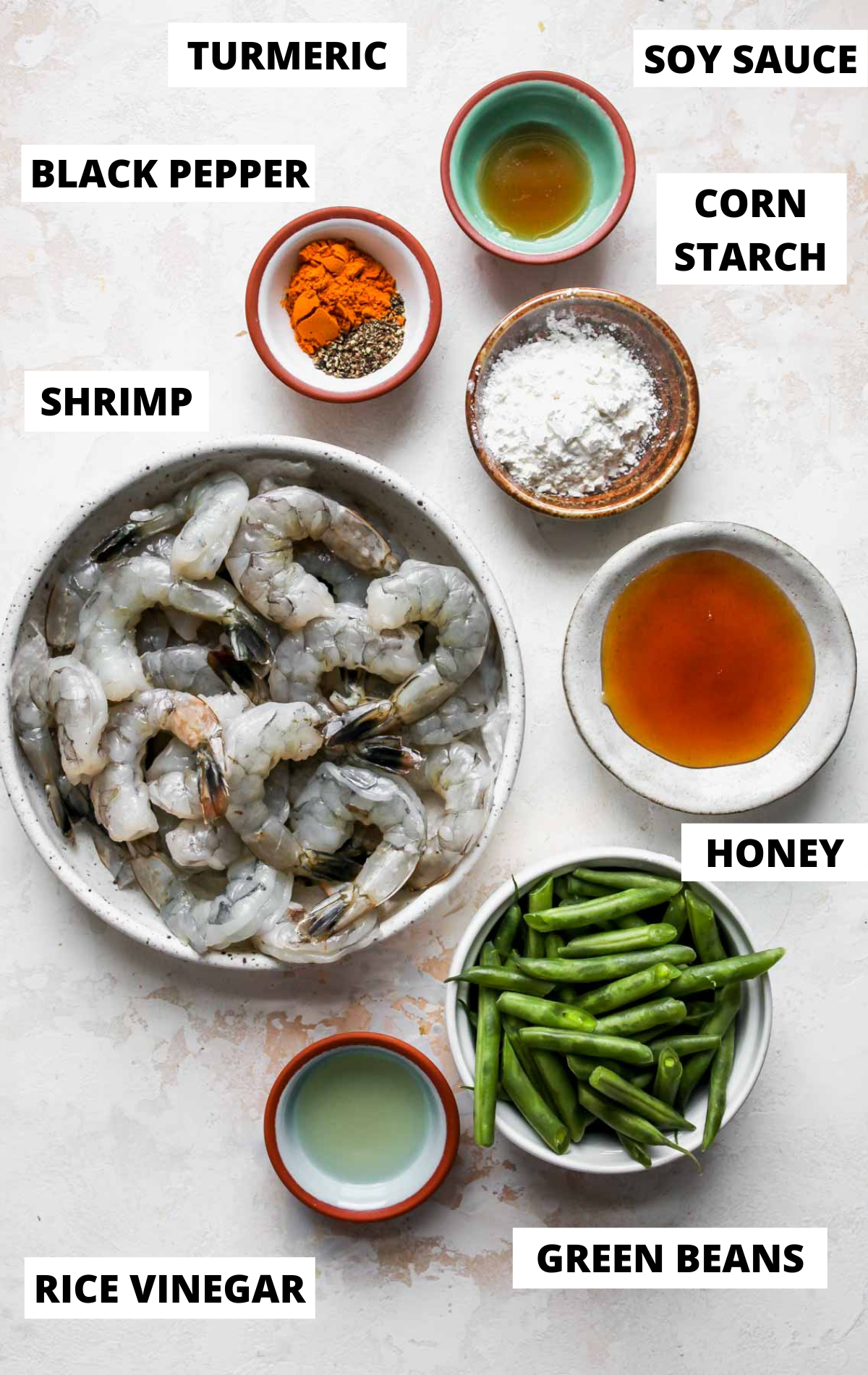Recipe ingredients in separate bowls on a white board with labels