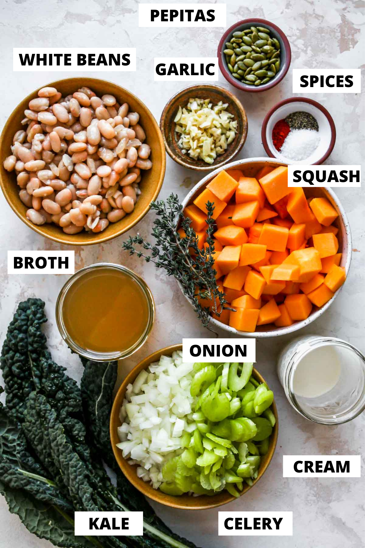 Recipe ingredients in separate bowls on a white board with labels.