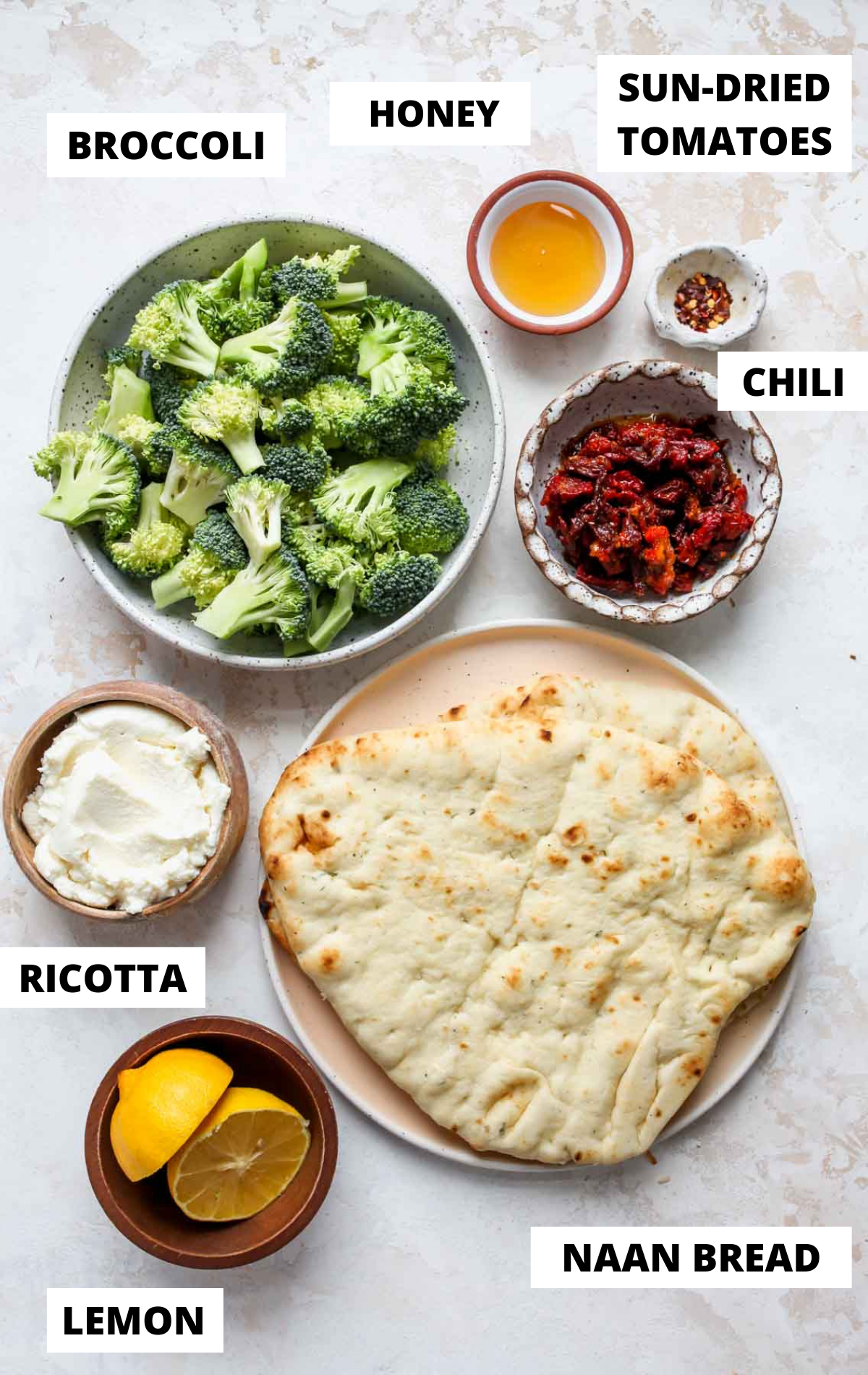 Recipe ingredients in separate bowls on a white board with labels