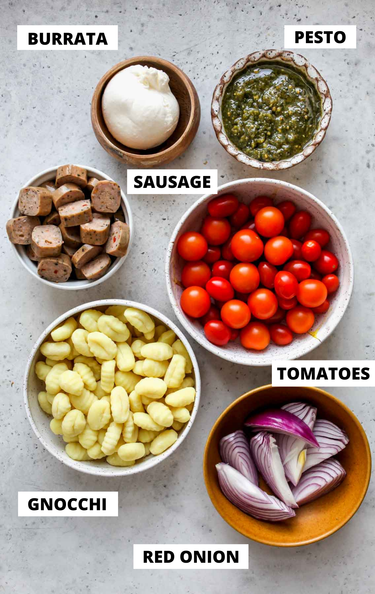 Recipe ingredients in separate bowls on a gray board with labels