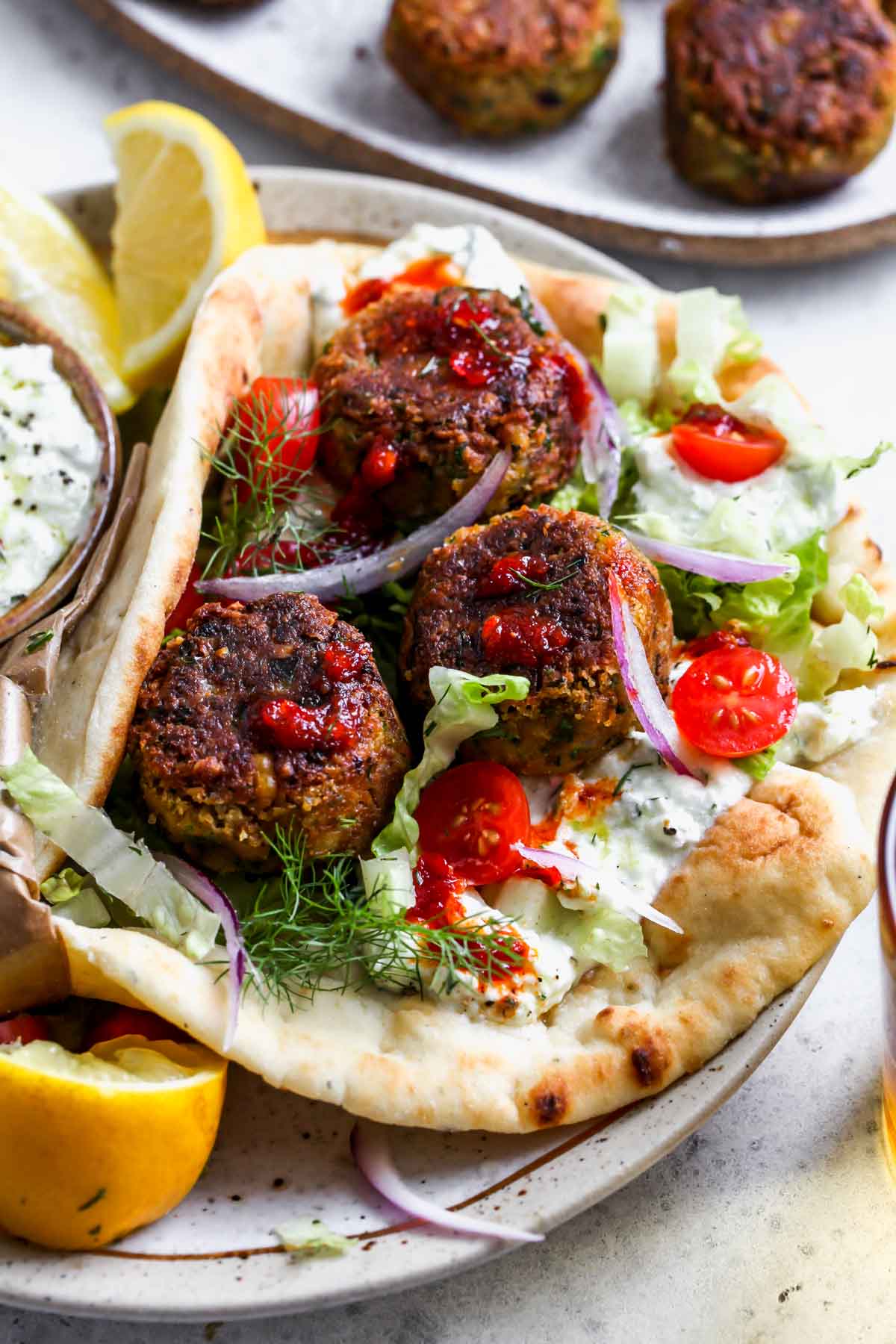 Falafel gyro assembled on a white and gold plate