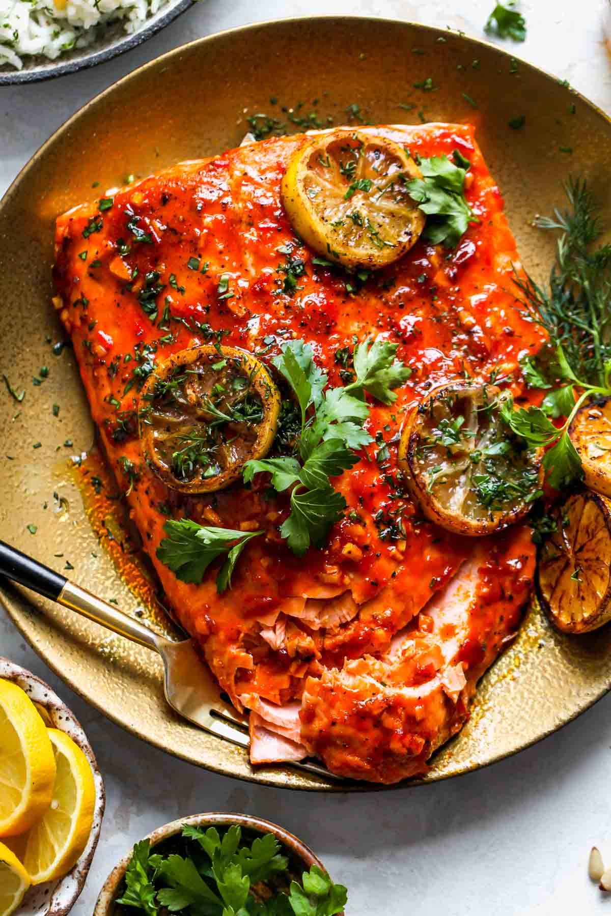 A fork flaking a fillet of salmon