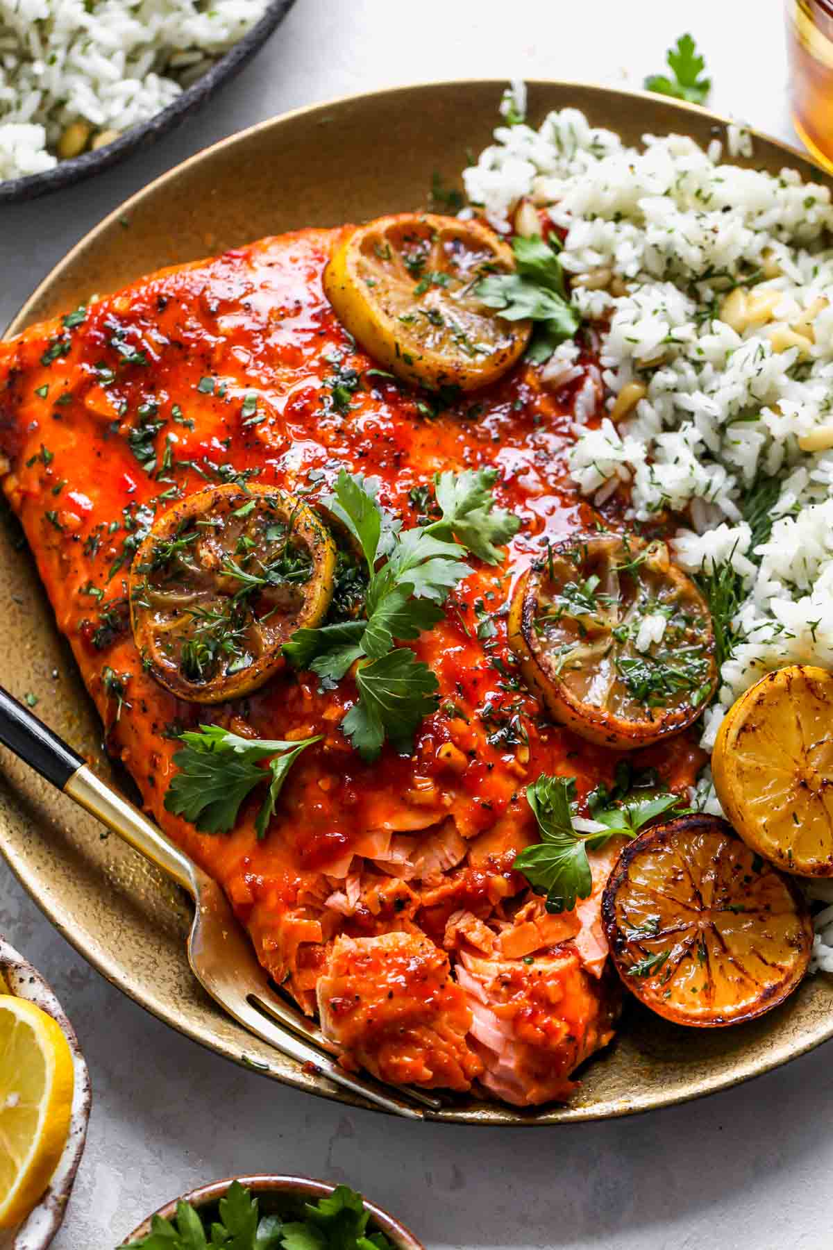 Baked salmon served with rice on a gold serving platter