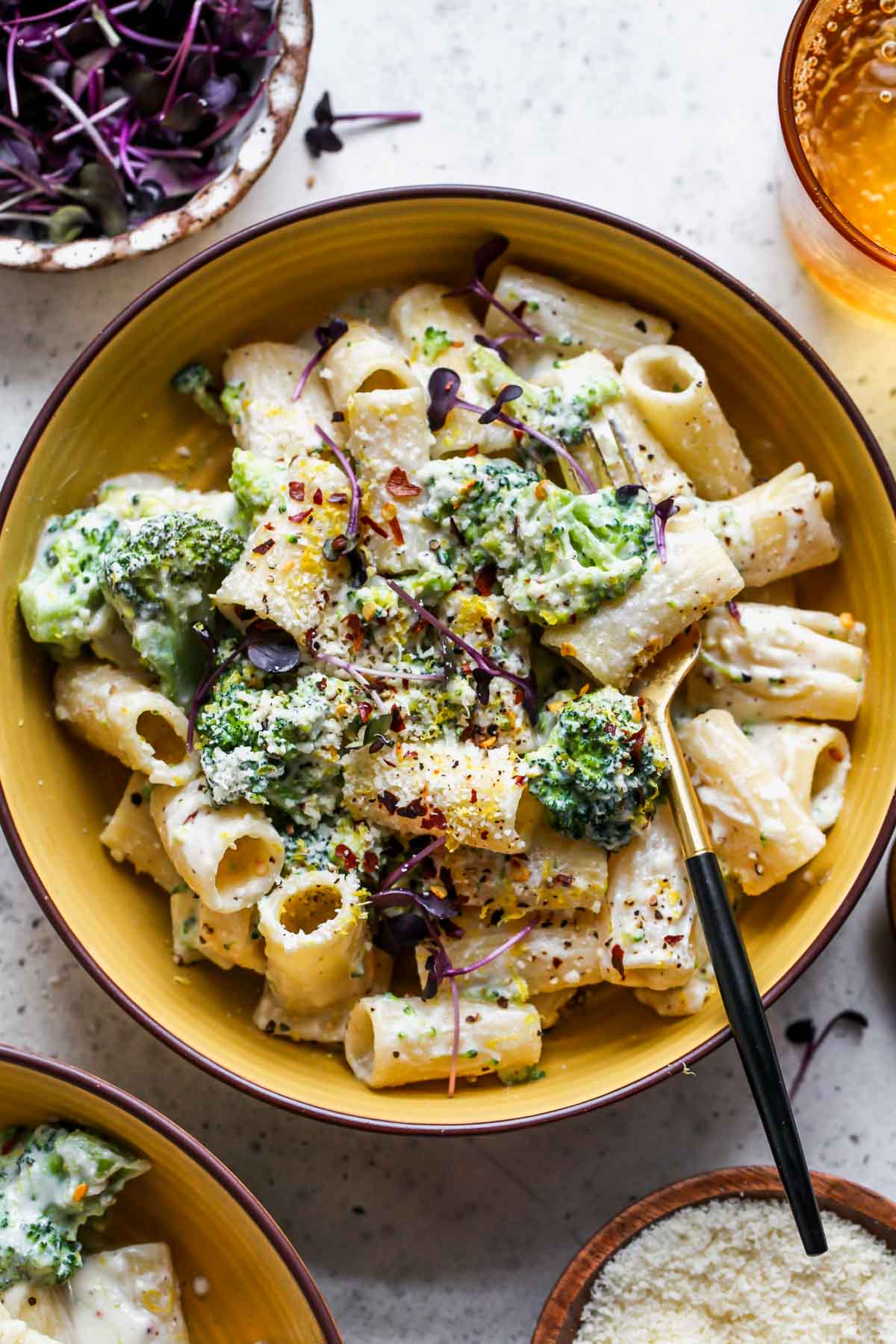 Rigatoni pasted topped in a ricotta sauce in a yellow bowl