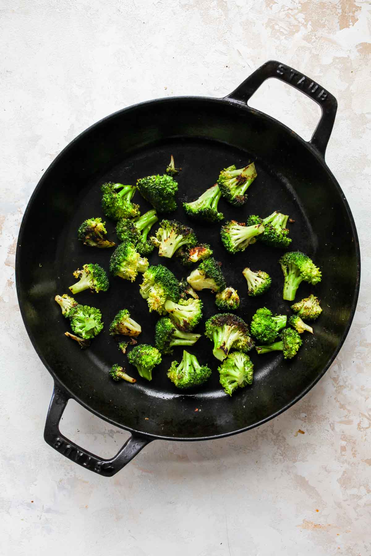 Sauteed broccoli florets in a cast iron skillet