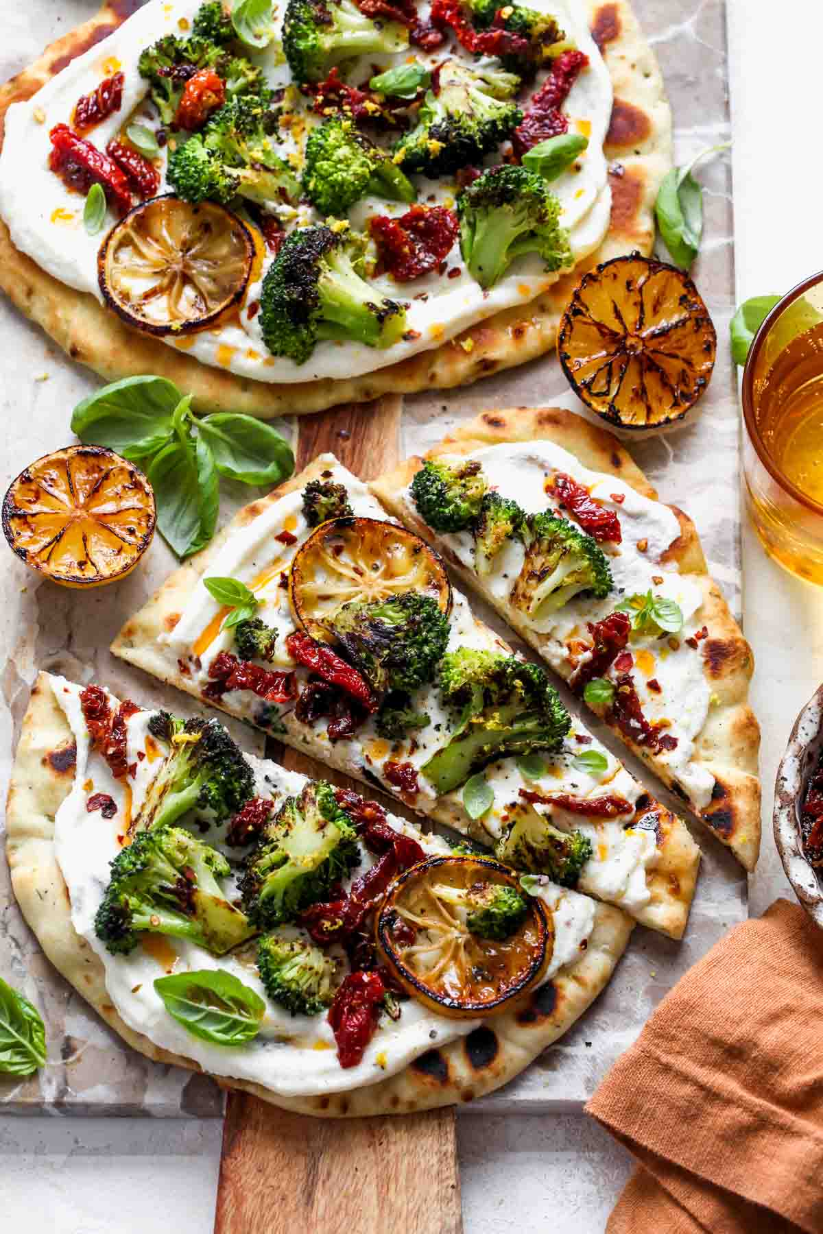 Naan pizza with whipped ricotta and veggies on a serving platter