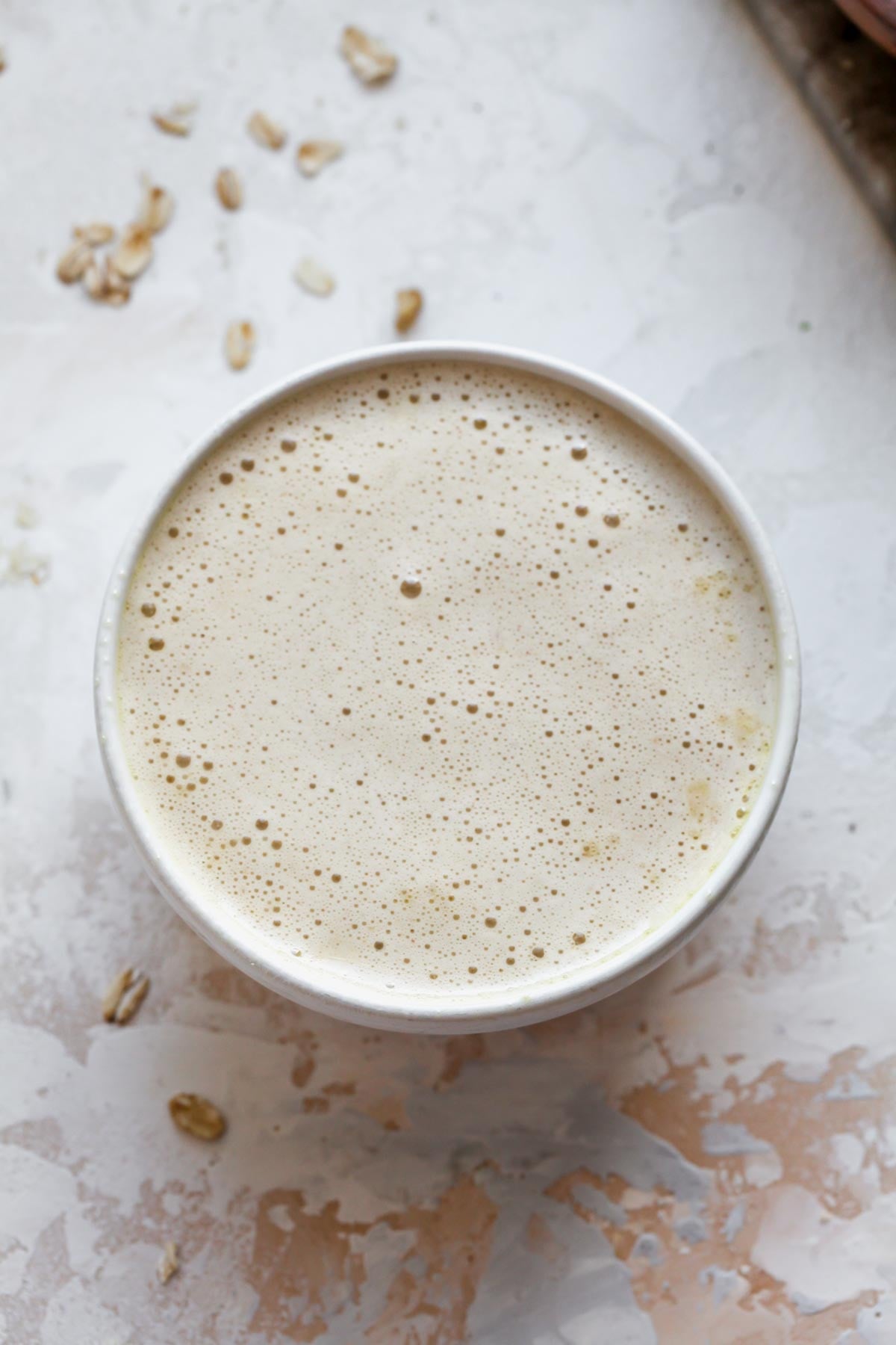 Oat batter poured into a white ramekin