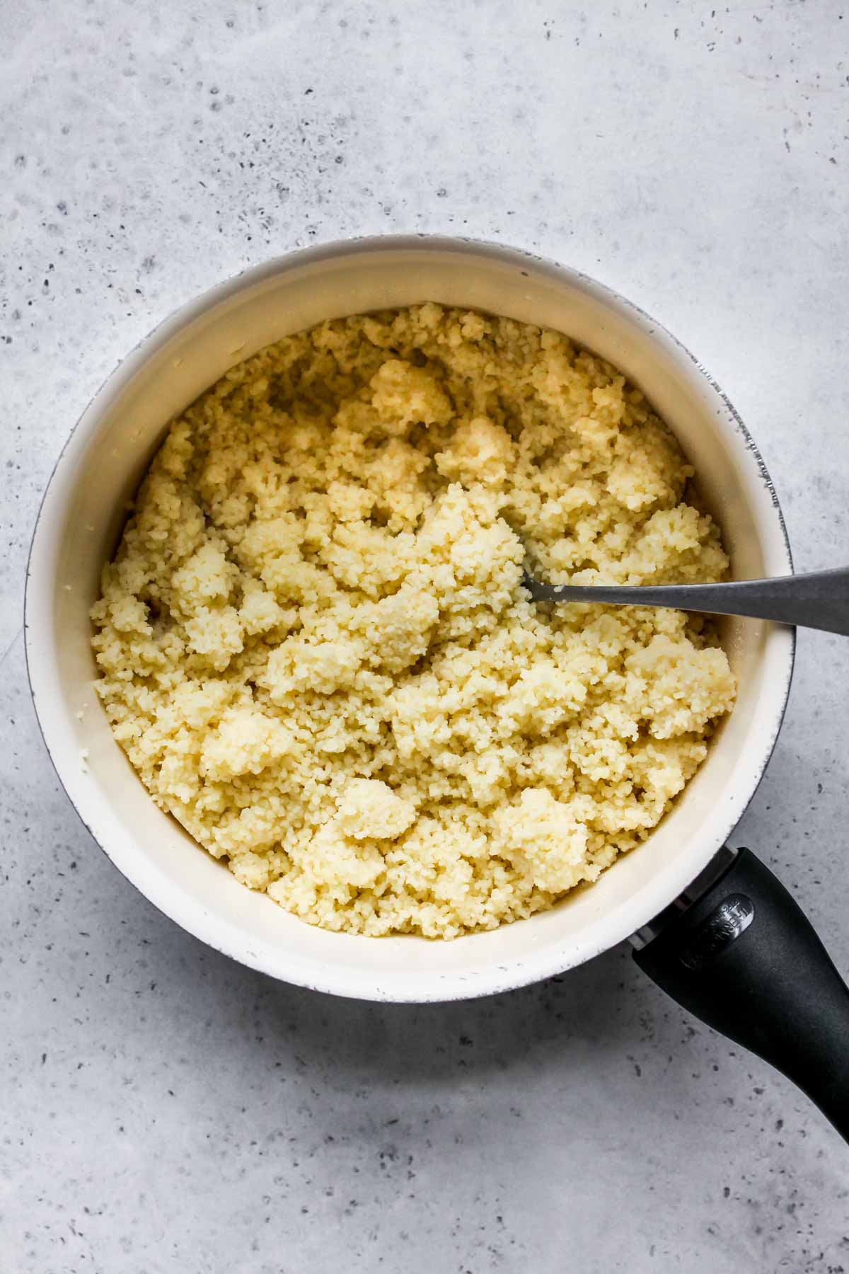 Cooked couscous in a medium saucepan