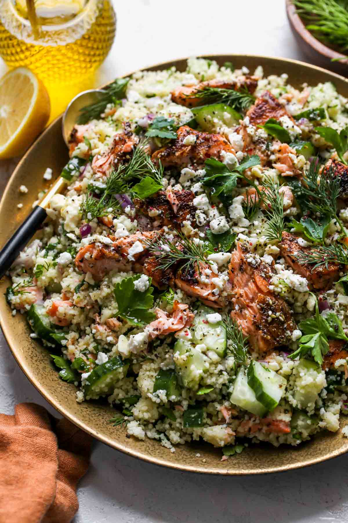 Assembled salmon salad with feta dressing on a serving platter