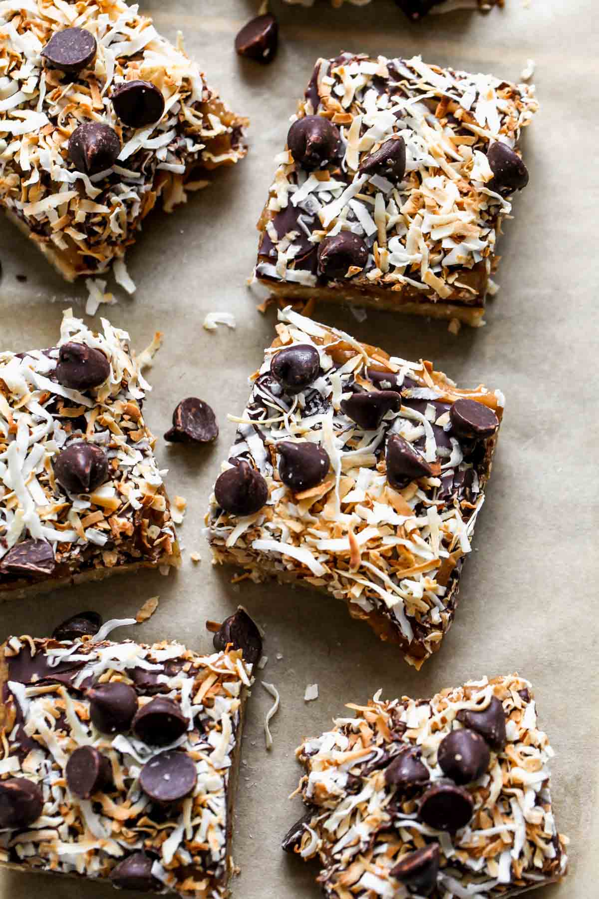 Magic bars cut into squares lined up on parchment paper