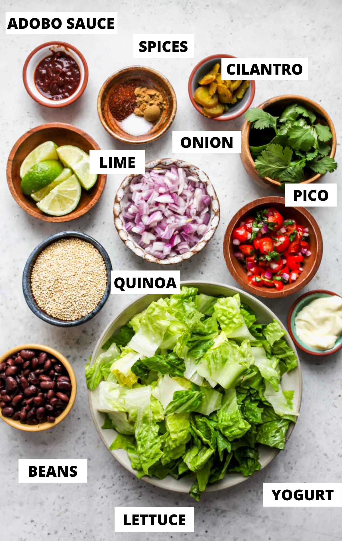 Recipe ingredients in separate bowls on a white board with labels