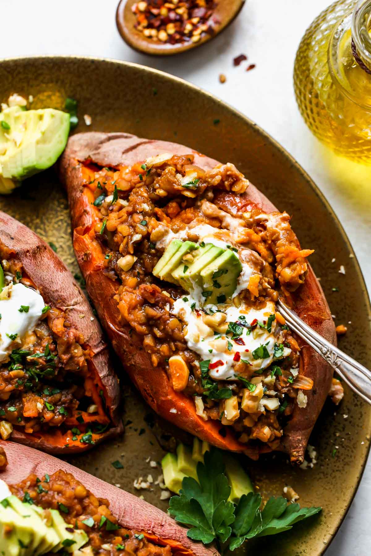 Stuffed sweet potatoes with a spoon taking out a bite