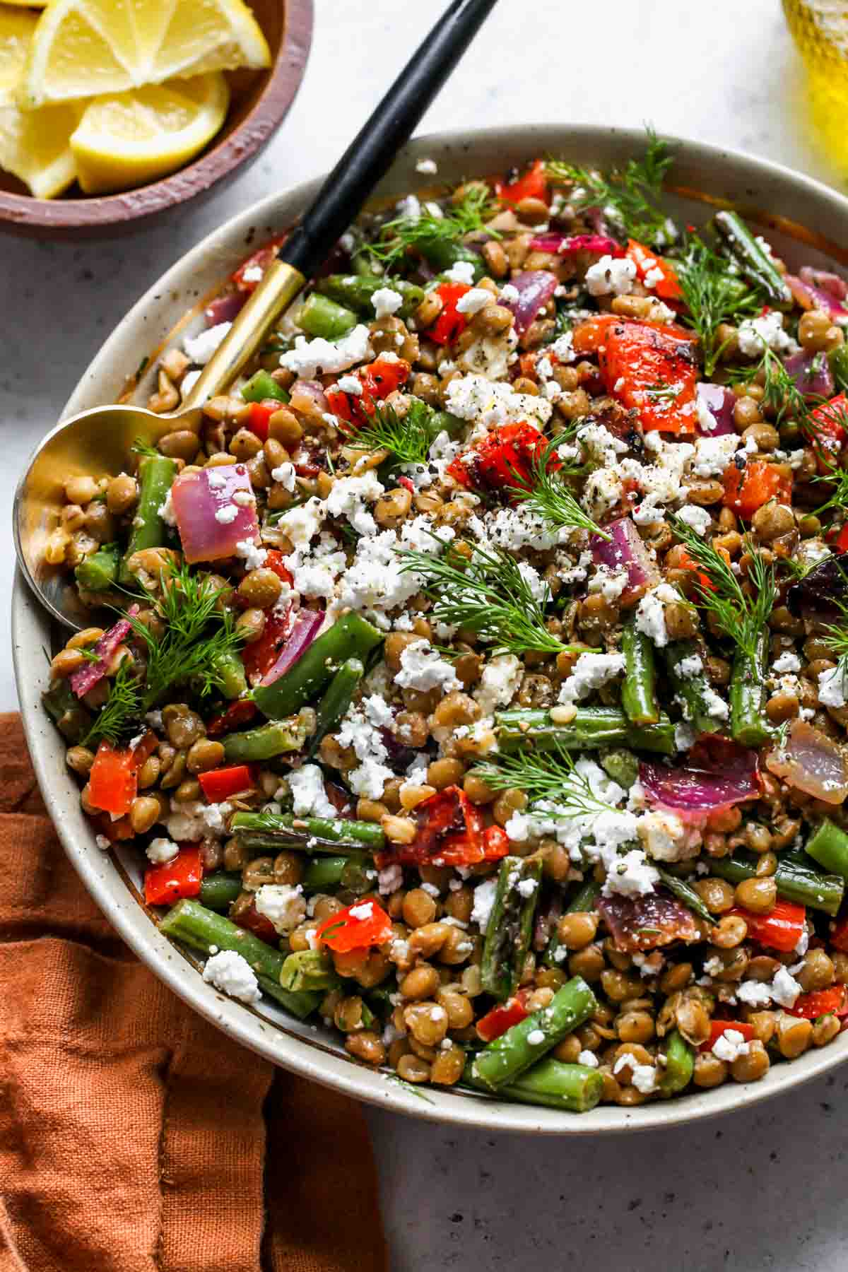 Mediterranean Lentil Salad topped with feta in a serving bowl.