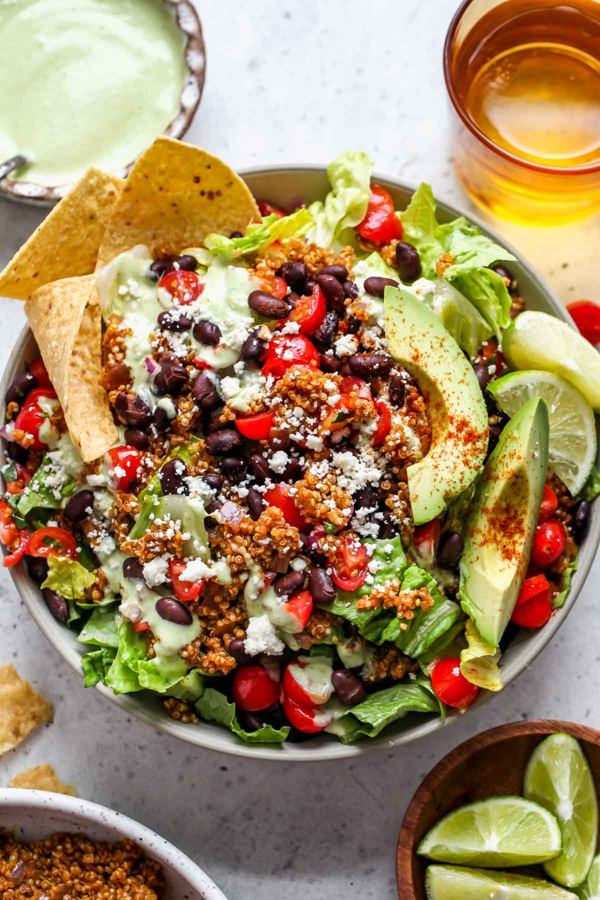 Quinoa taco salad styled in a bowl topped with Baja dressing