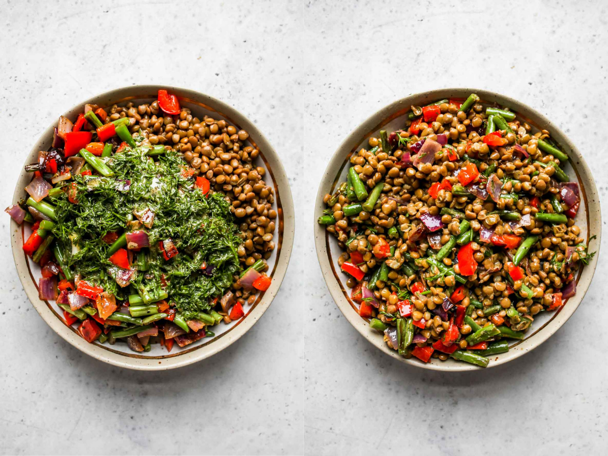 Lentils, sauteed veggies, and dressing being mixed in a bowl.