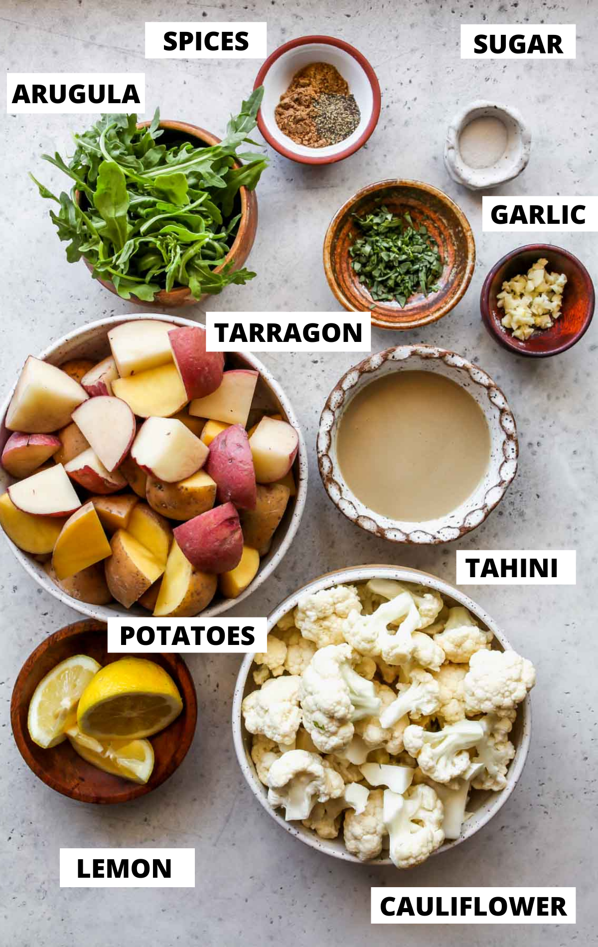 Recipe ingredients in separate bowls on a grey board with labels