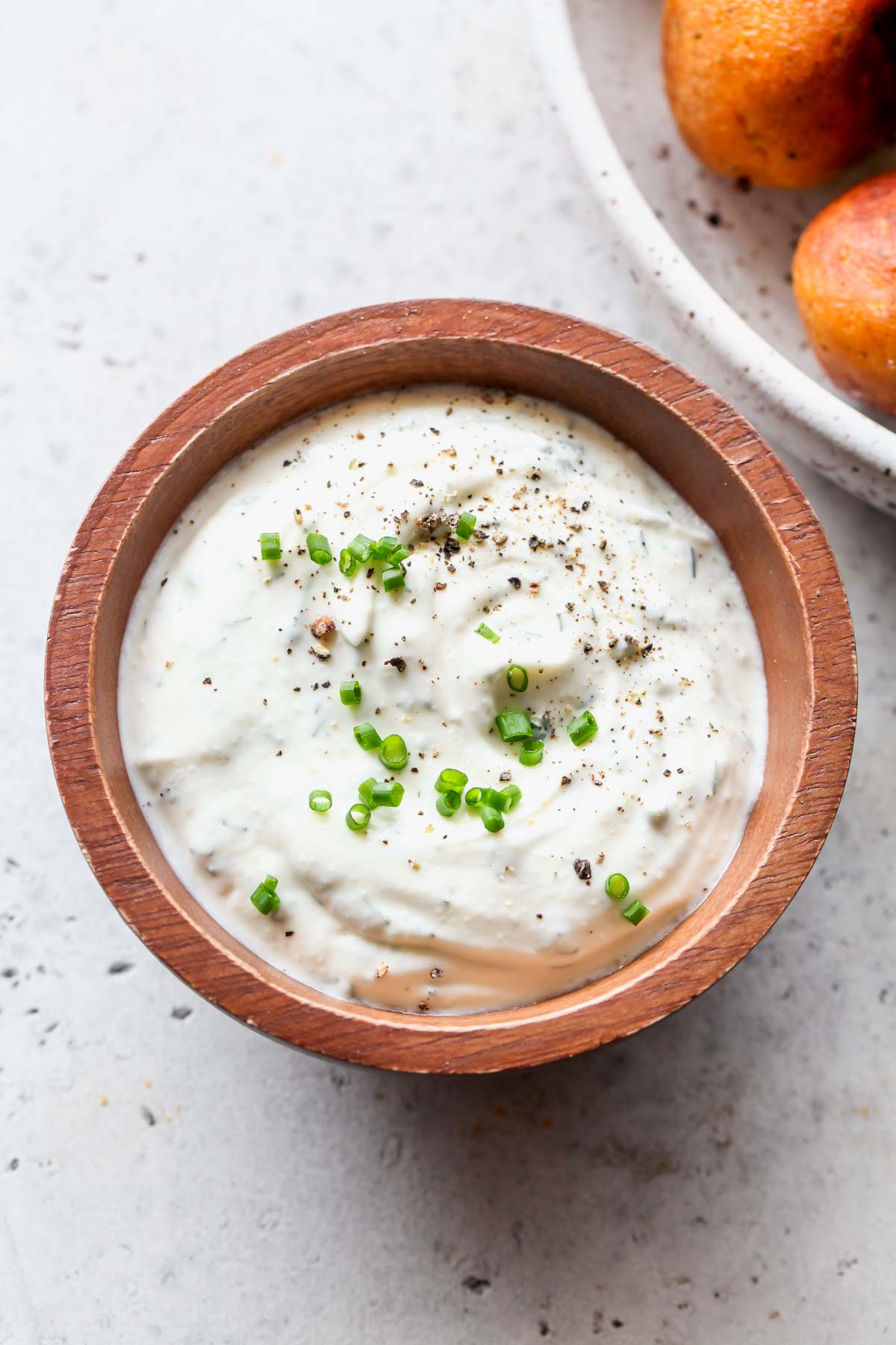 Yogurt ranch dip in a wooden bowl