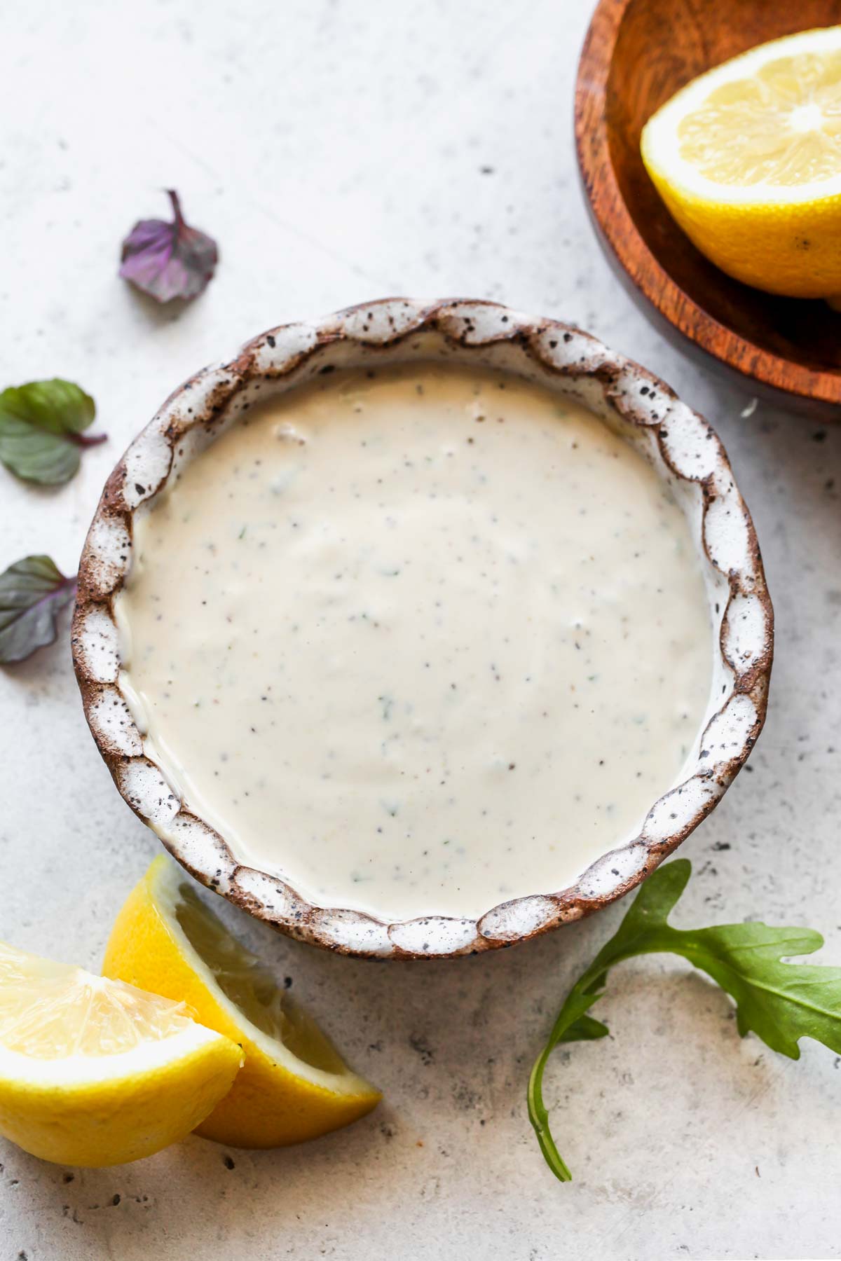 Tarragon-tahini dressing in a white bowl