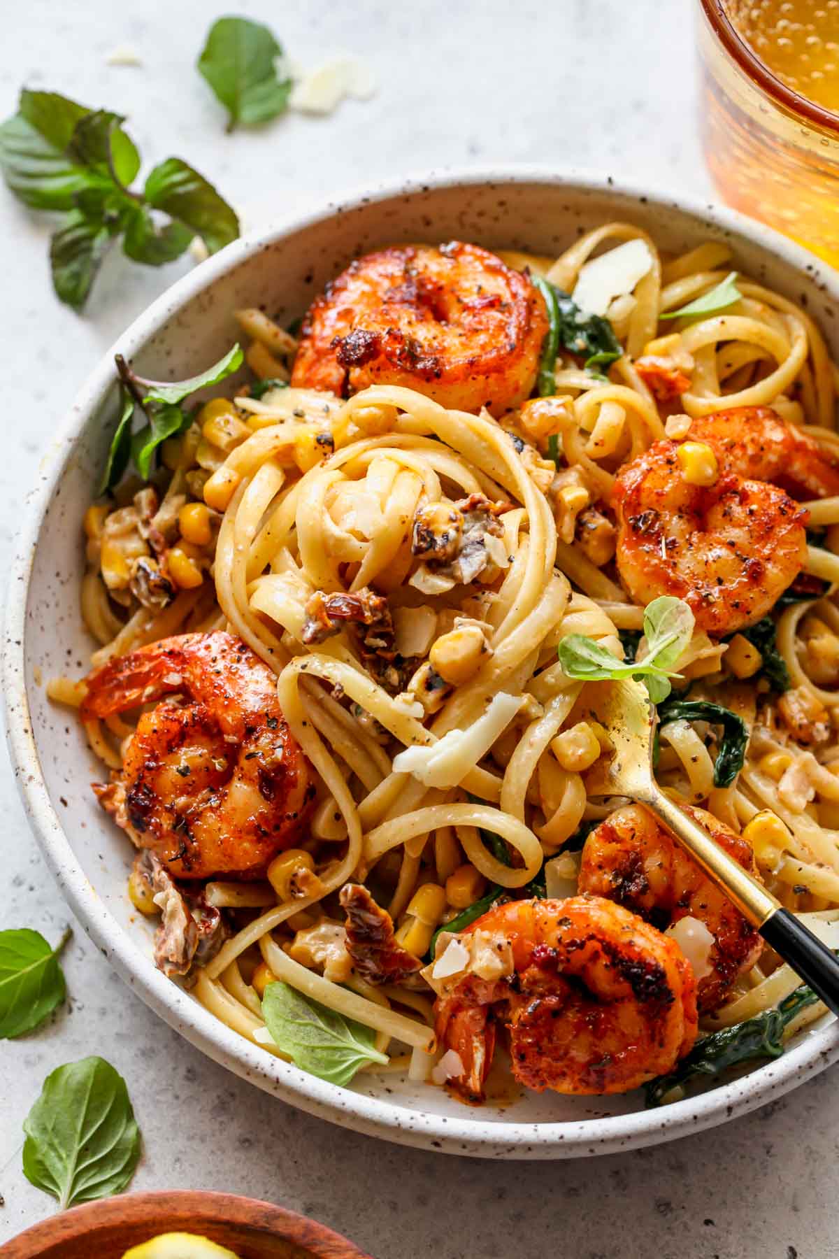 A fork twirling a bite of creamy shrimp linguine
