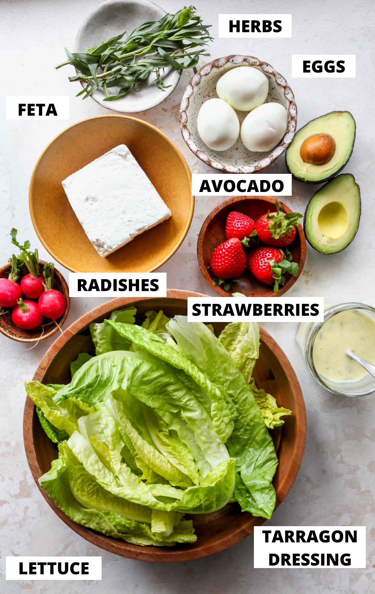 Recipe ingredients in separate bowls on a white board with labels