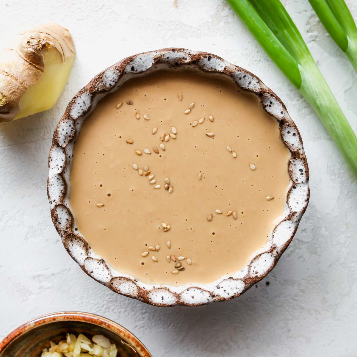 Creamy ginger sauce in a white bowl.