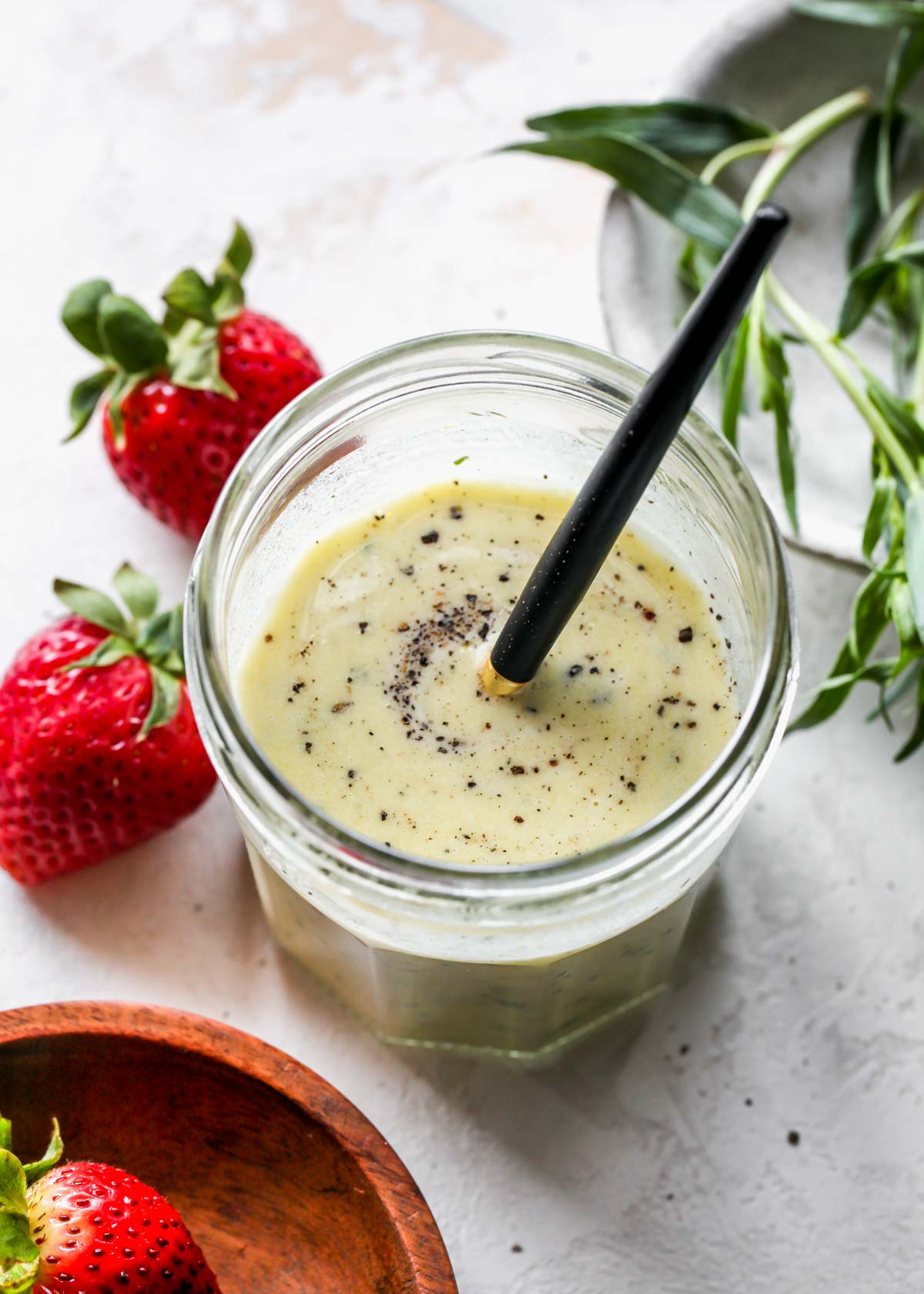 Tarragon dressing being whisked in a jar