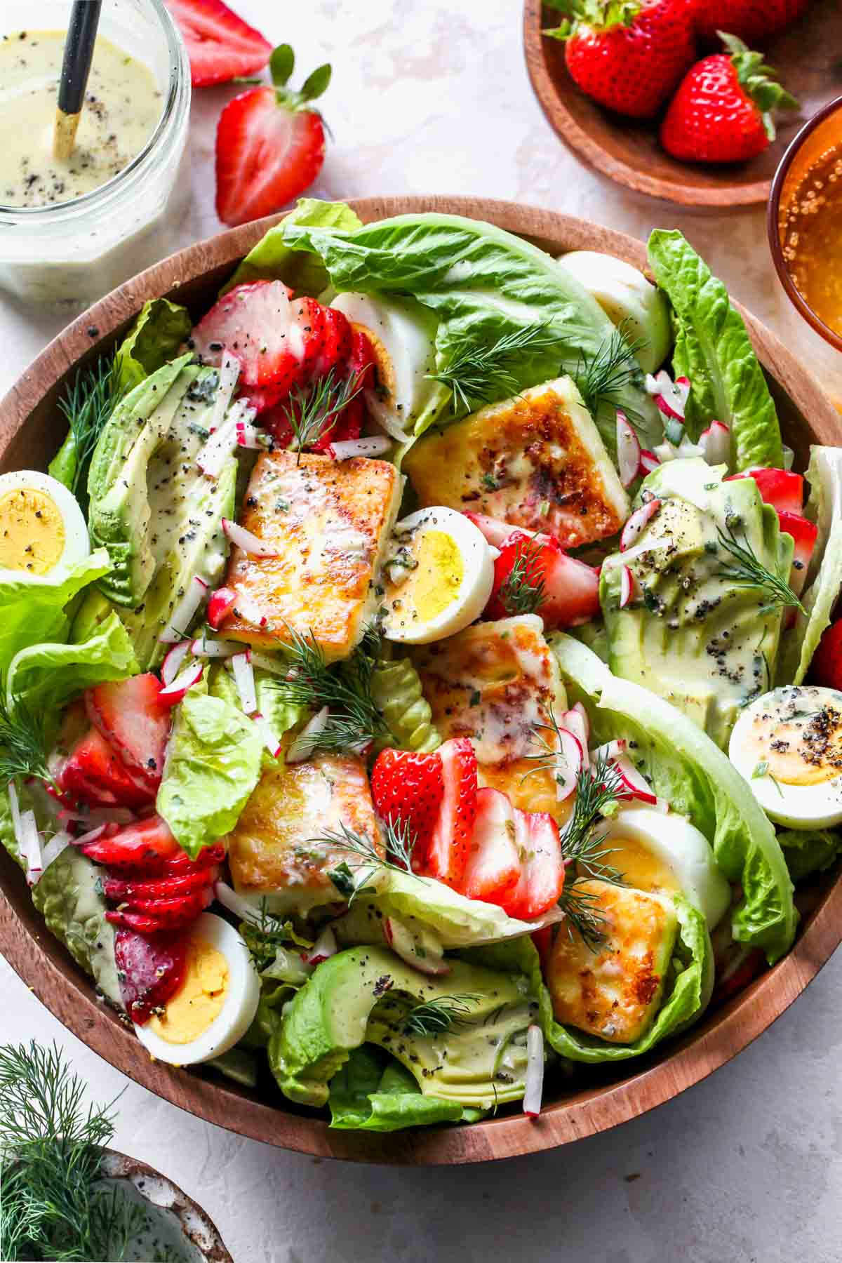 Strawberry Cobb Salad in a wood serving bowl.