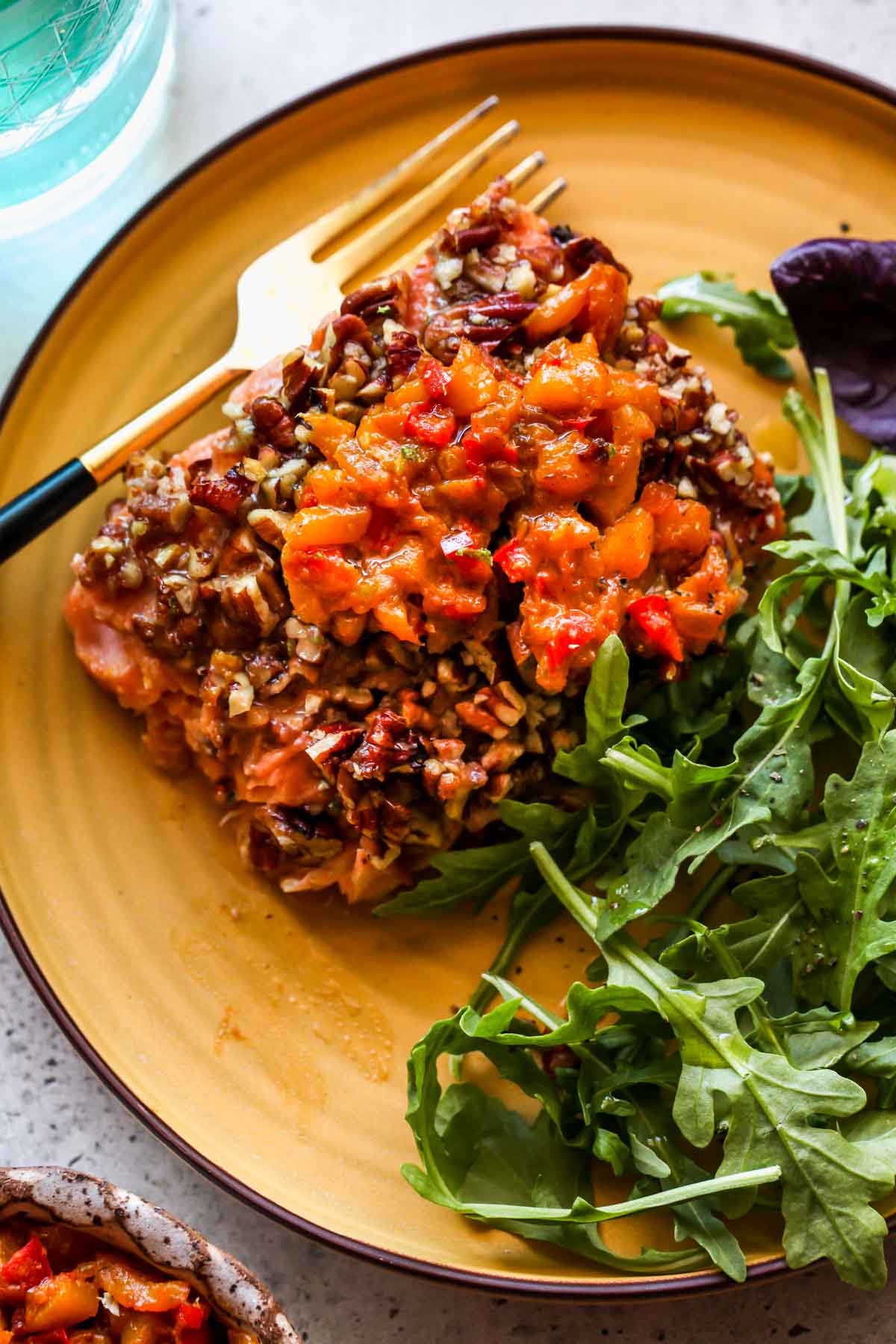 Salmon fillet on a plate with an arugula salad