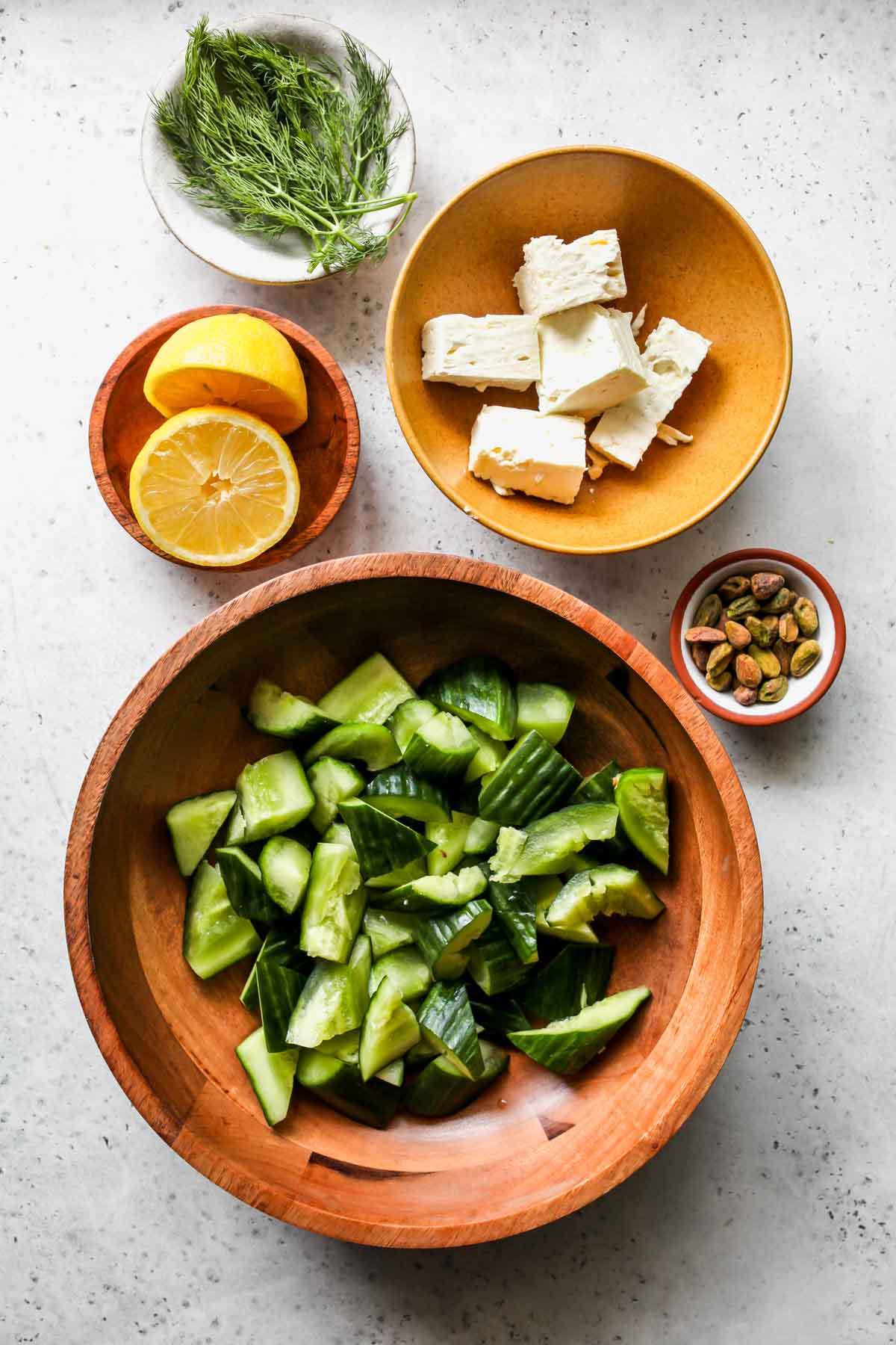 Recipe ingredients in separate bowls on a work surface.