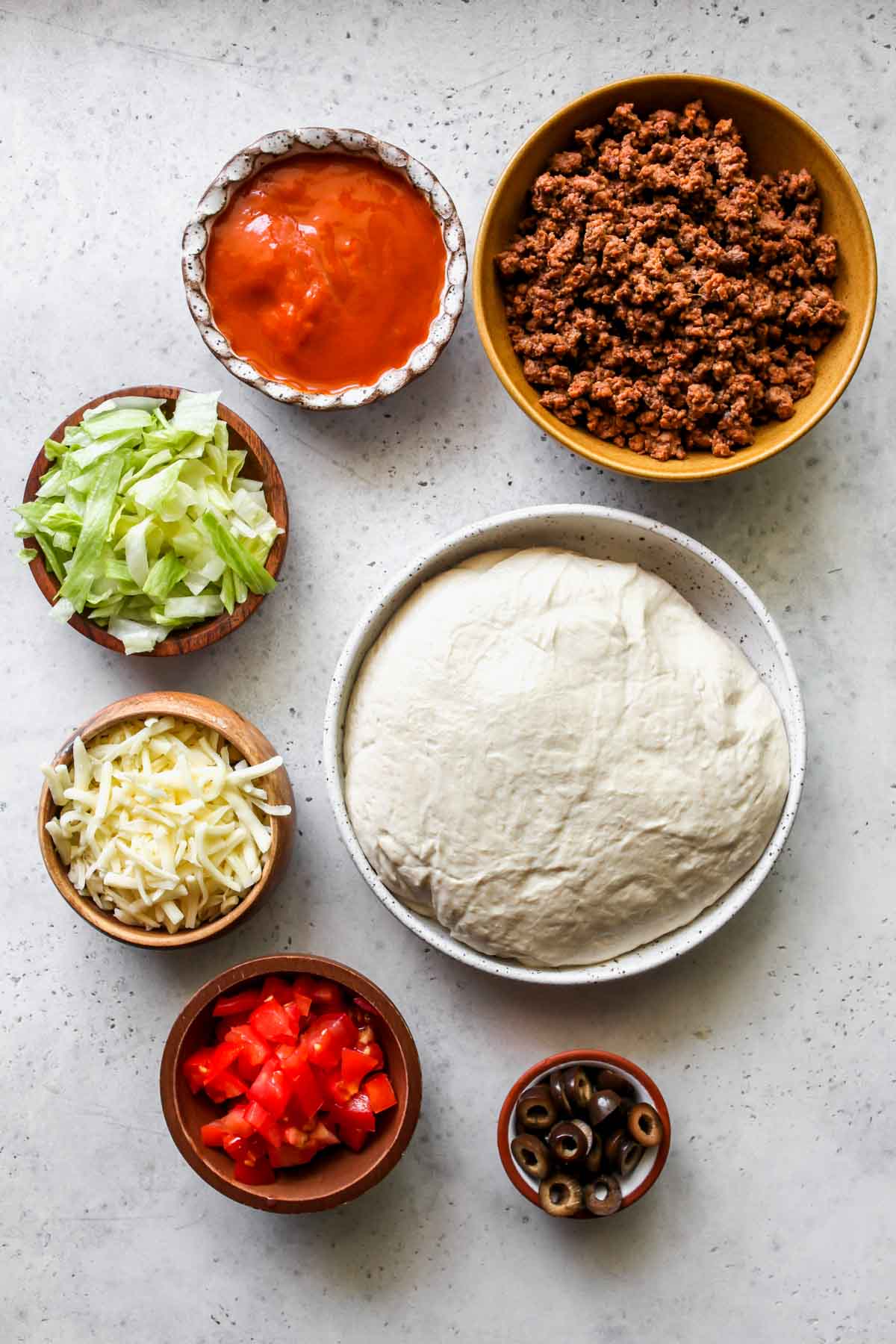 Recipe ingredients in separate bowls on a work surface