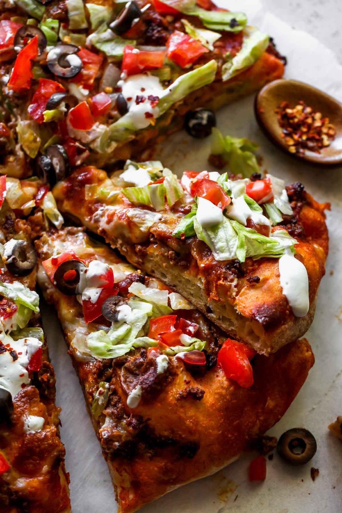 Slices of taco pizza stacked on each other
