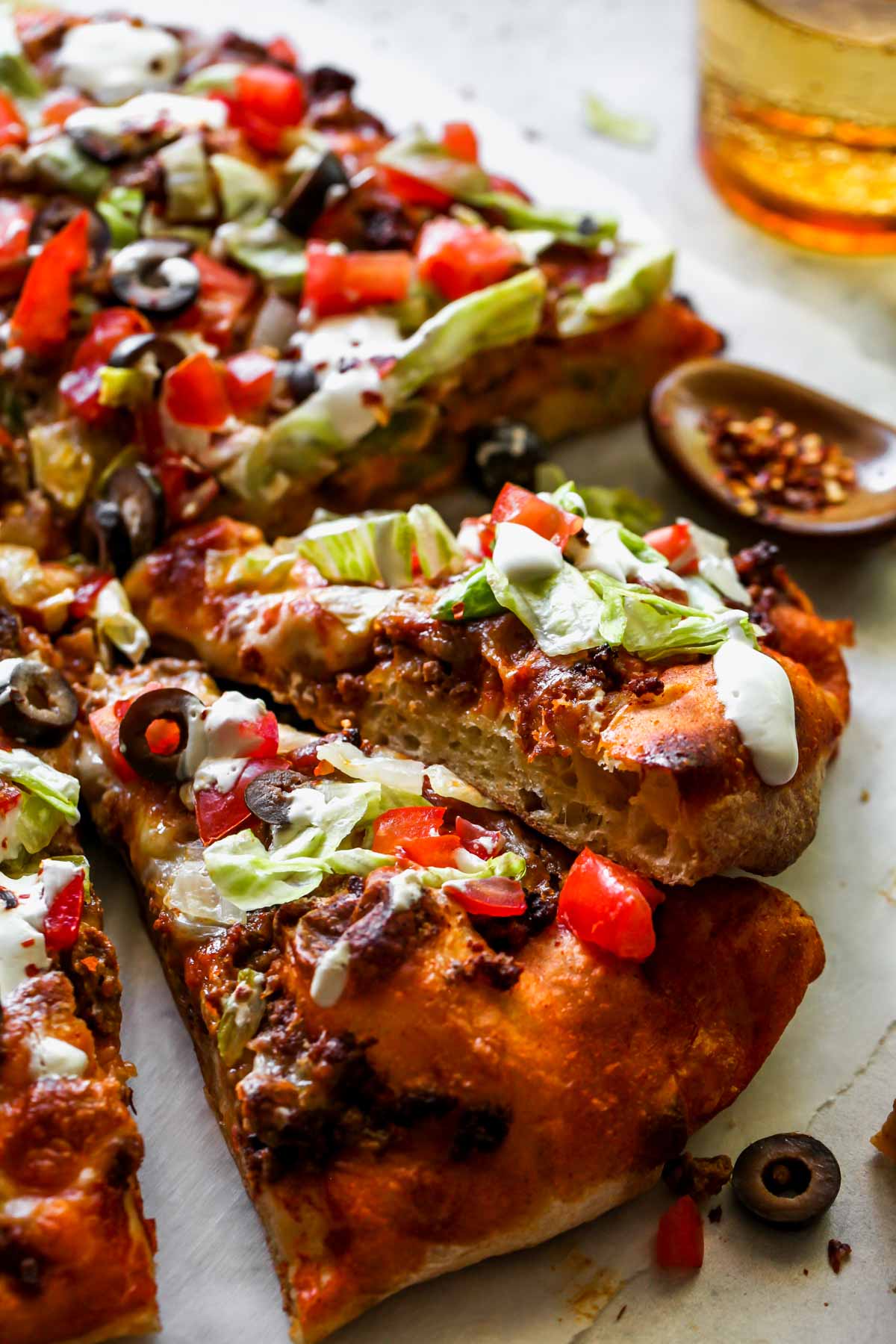 Sliced taco pizza on a work surface