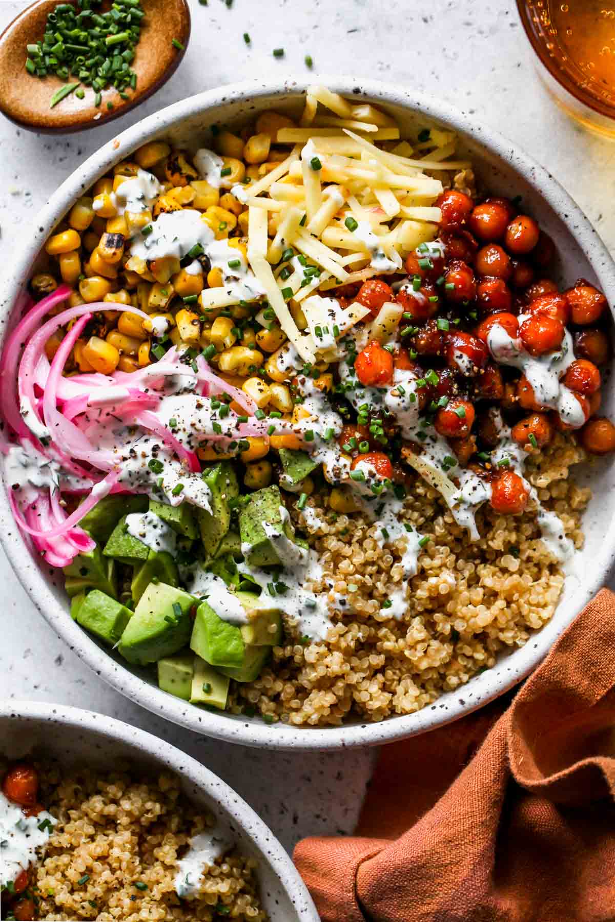 Chickpea quinoa bowl with avocado, red onion, corn, and ranch dressing