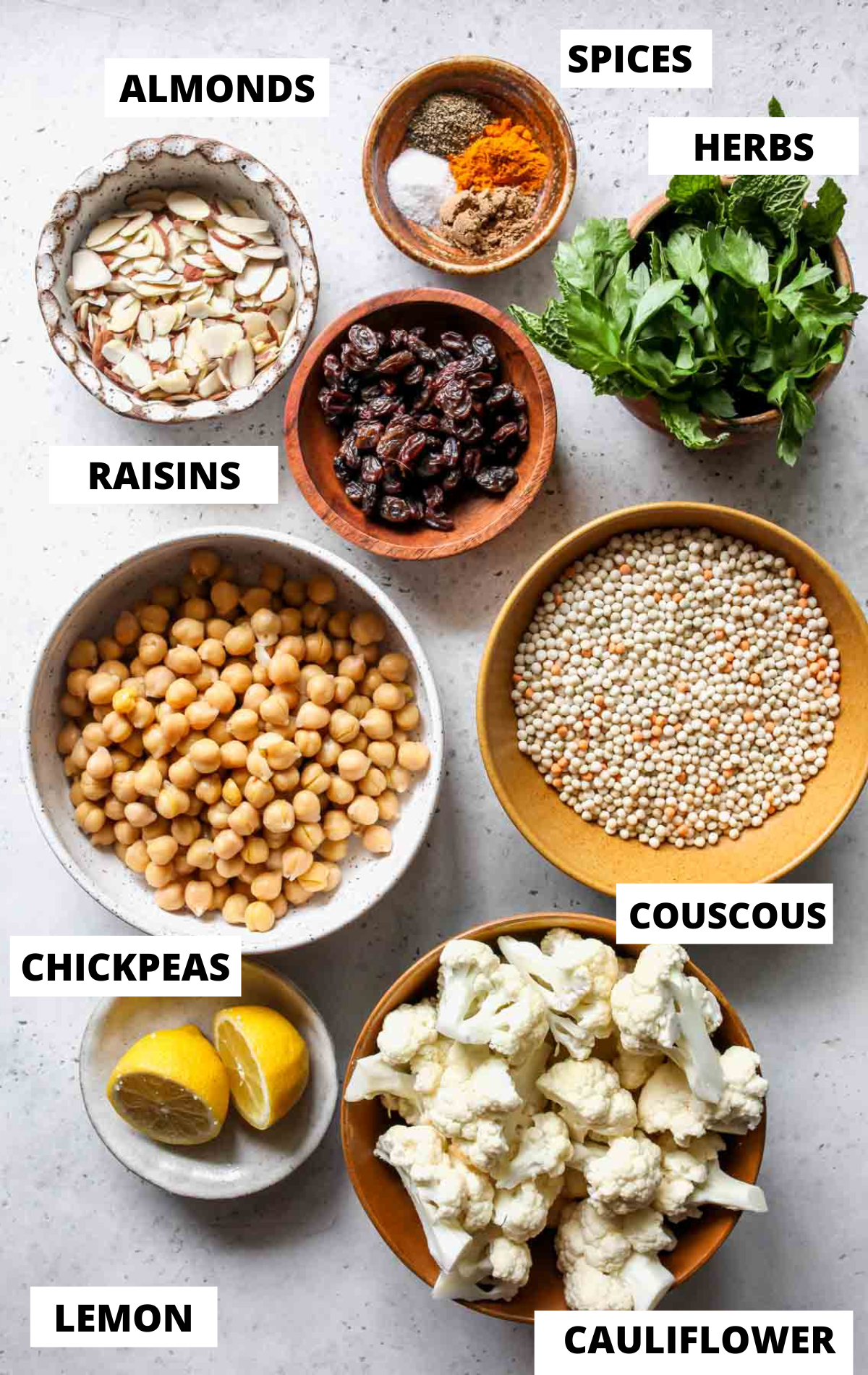 Recipe ingredients in separate bowls on a grey board with labels