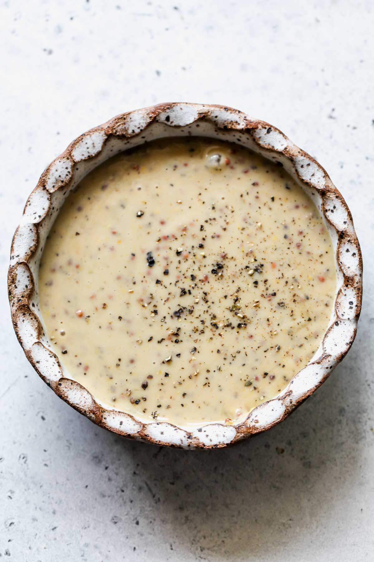 Maple-mustard tahini sauce mixed in a white bowl