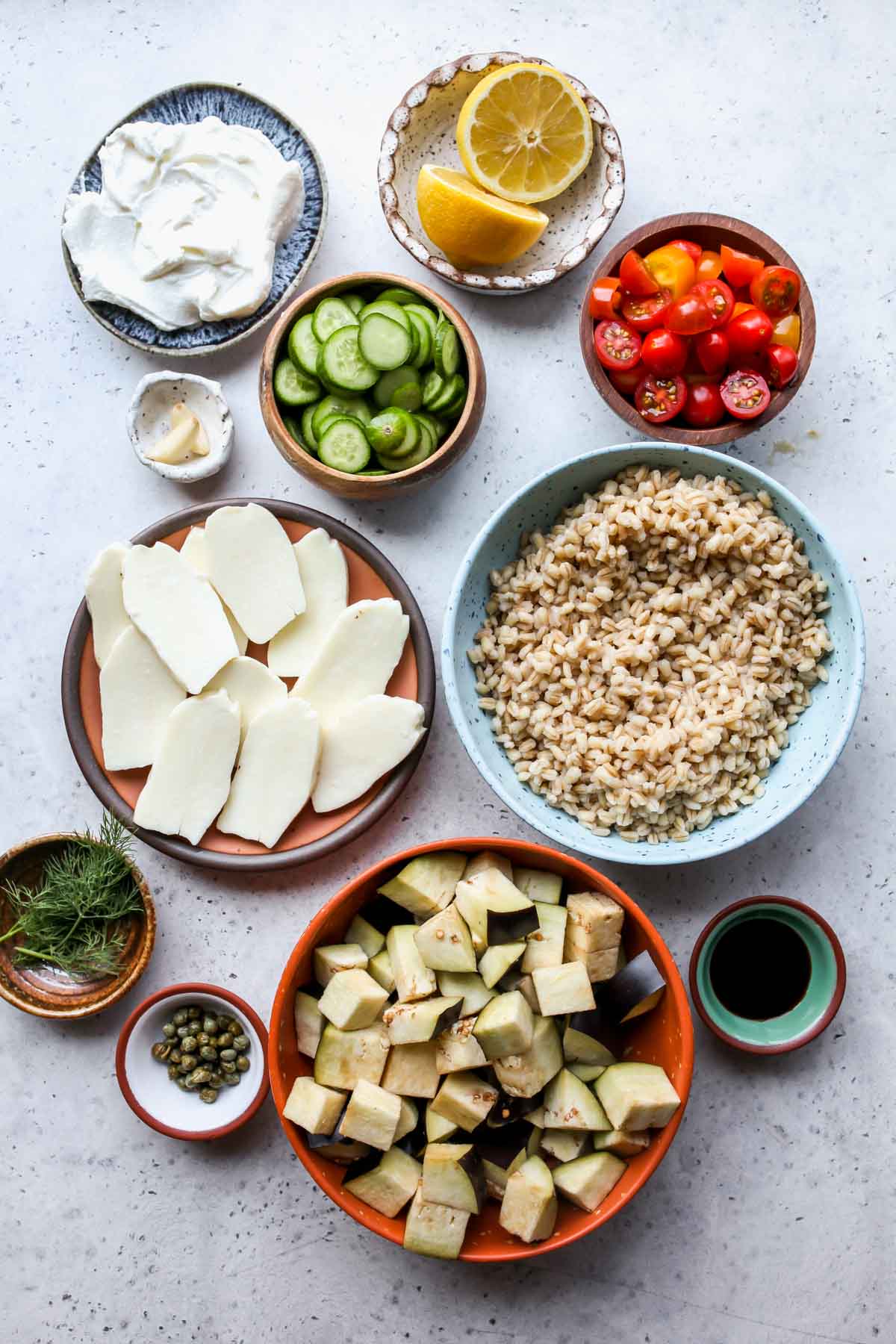 Recipe ingredients in separate bowls on a blue surface